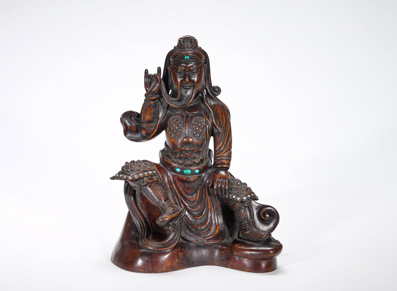 Qing Dynasty, Agarwood Inlaid with Turquoise Seated Statue of Guan Gong: Agarwood Statue of Guan Gong in Relaxed Seated Pose Inlaid with TurquoiseCarved from a single piece of agarwood, the statue depicts Guan Gong in an informal seated posture. He wears a warrior headgear