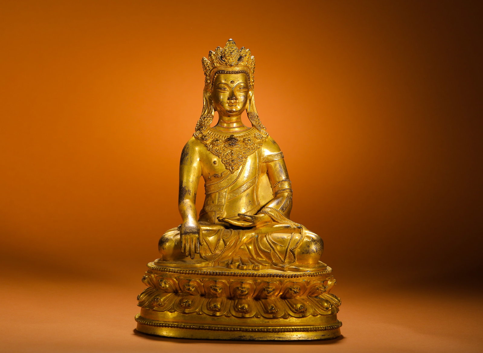 Qing Dynasty, Seated Statue of Sakyamuni with a Gilded Bronze Crown: Qing Dynasty fully gilded bronze seated crowned Shakyamuni Buddha statue blending Han and Tibetan styles, cast from solid brass with thick full gilding. The Buddha wears five-leaf jewel crown, sits fu