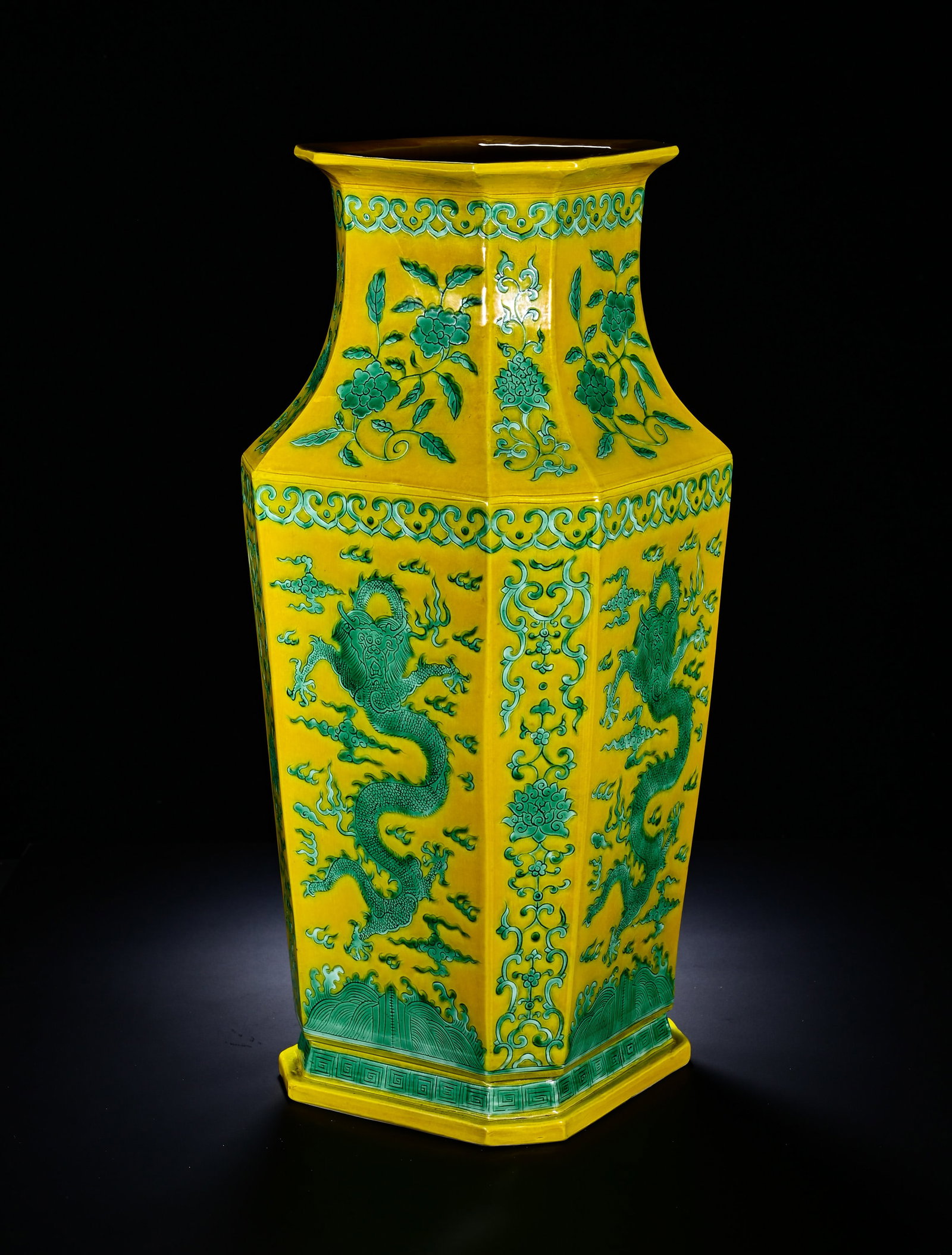 Qing Dynasty, Qianlong Period, Yellow Ground Green Colored Cloud Dragon Flower Pattern Octagonal: The imposing octagonal vase has flared rim, straight neck, sloped shoulder, deep straight body and octagonal foot. The whole surface is covered with bright even yellow glaze, decorated in green enamel