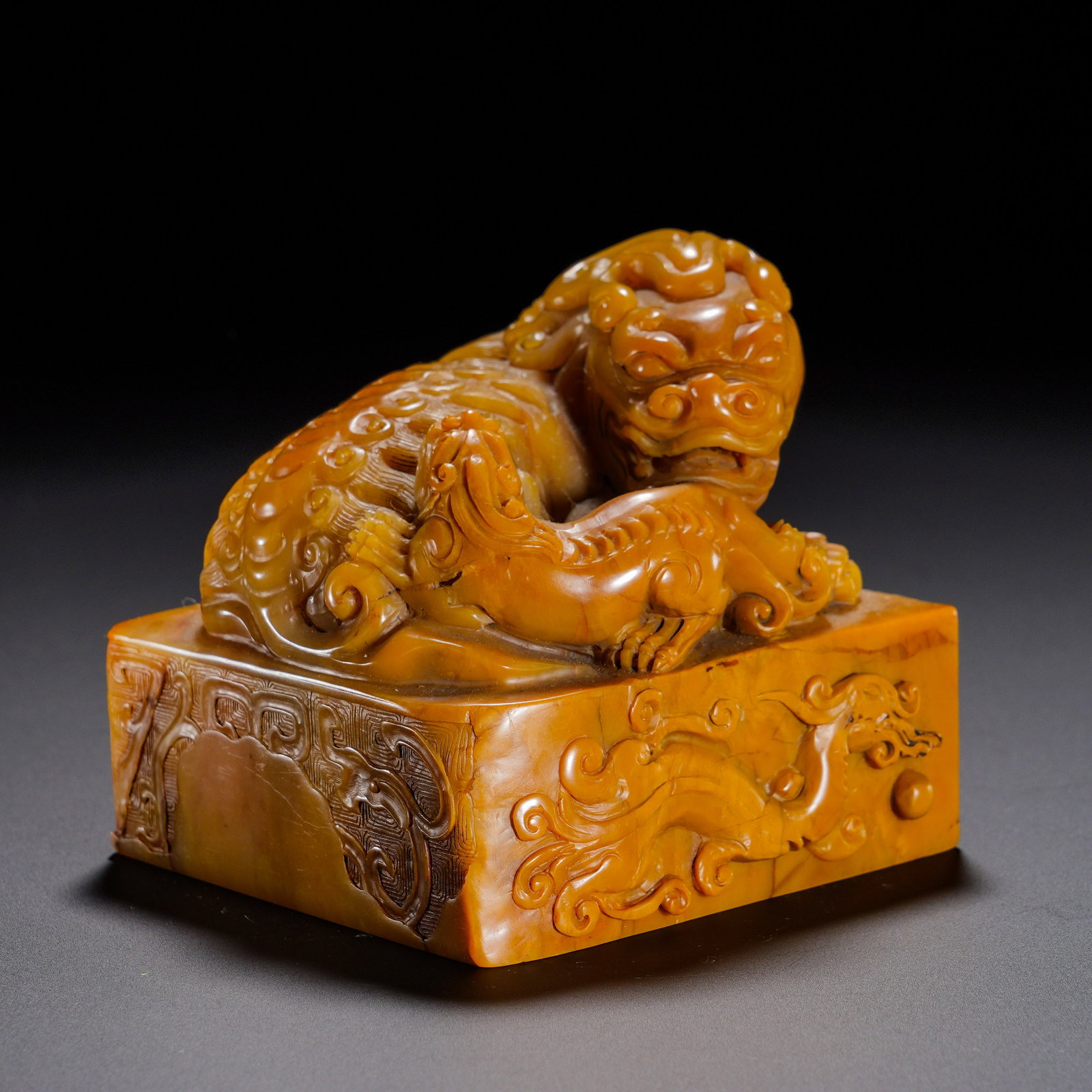 Qing Dynasty, Shoushan Tian Huang Taishi Shaoshi Button Square Seal: A substantial square seal of Qing dynasty carved from Shoushan Tianhuang stone. The stone is thick and oily in rich honey-yellow tone, with compact texture and well-aged mellow patina. The knob is rou
