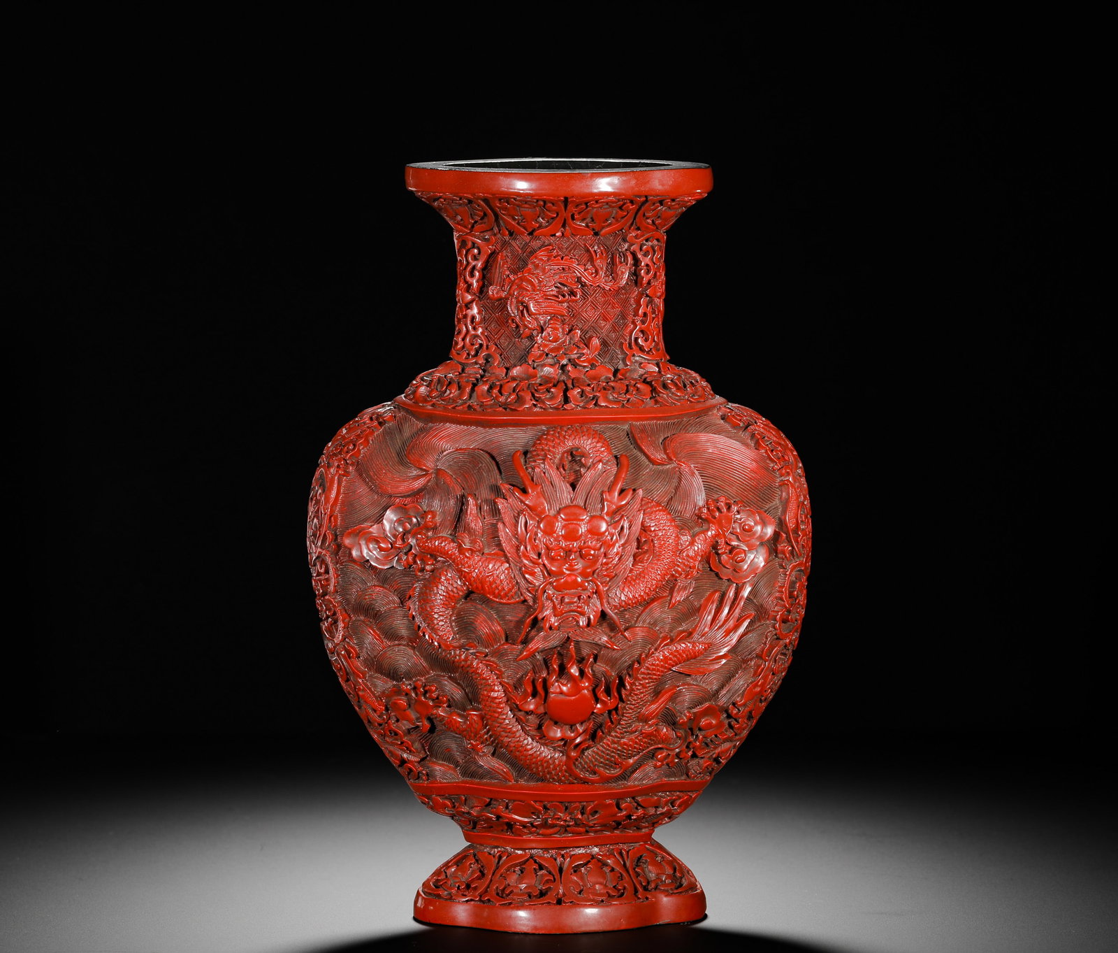 Qing Dynasty, During the Reign of Emperor Qianlong Lacquered Jars Were Made in the Imperial Court: Carved red lacquer begonia vase, Qianlong reign of Qing Dynasty, multi-layer red lacquer carved with dragon chasing pearl over sea waves, lotus and beast patterns on neck and foot, cracked black lacqu