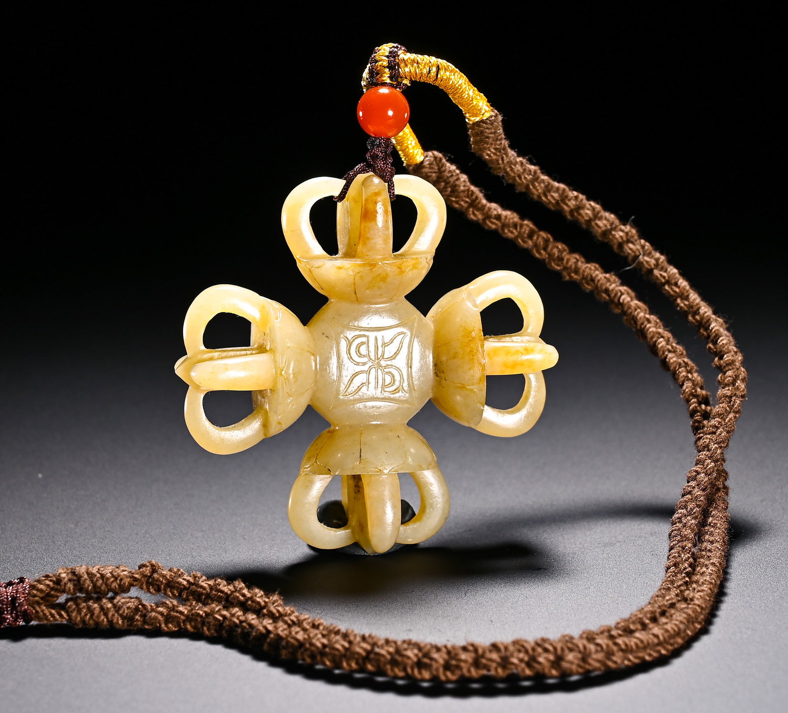 Qing Dynasty, Hetian Jade Cross-Shaped Vajra Pendant: Qing Dynasty Hetian jade pendant of cross vajra. The ornament is symmetrically carved with four vajras extending in four directions, and Sanskrit symbols are incised on the central square plaque. Cros