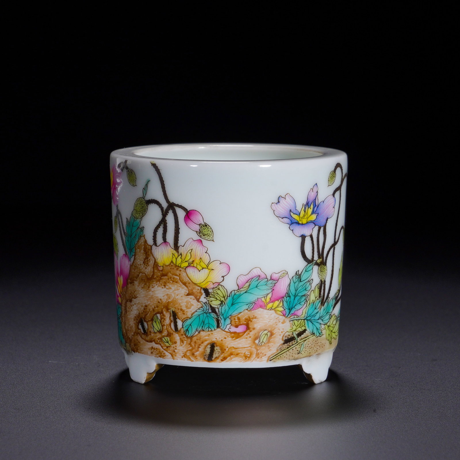Qing Dynasty, Qianlong Period, Three-Legged Tube Incense Burner with Pastel Cave-Stone Flower: An elegant incense burner of the Qianlong reign for scholar-studio use. It adopts a straight cylindrical body with a neat rim, supported by three gilded ruyi-shaped feet. The lustrous white glaze serv
