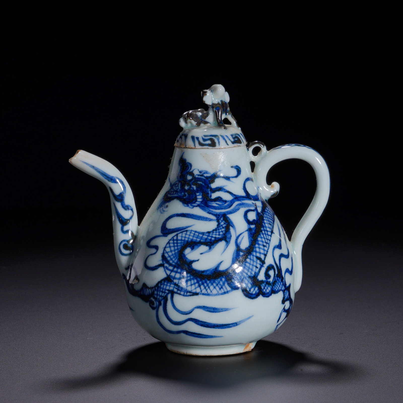 Yuan Dynasty, Blue and White Porcelain Dragon-Patterned Animal-Shaped Pear-Shaped Ewer: A blue-and-white wine ewer of Yuan dynasty in classic pear-shape. It has plump body, restrained mouth, slender curved spout and scroll-styled handle. The lid is surmounted by a mythical beast knob, de