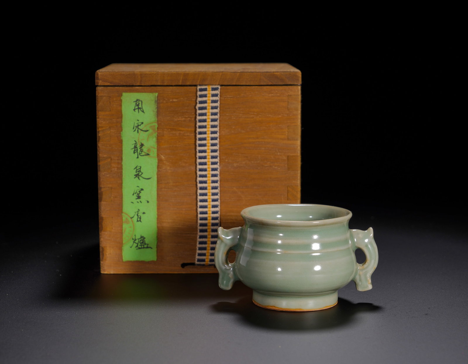 Southern Song Dynasty, Celadon Fish-Ear Stringed Incense Burner from Longquan Kiln: Modeled after archaic bronze gui vessel, this censer features flared mouth, contracted neck and rounded belly decorated with horizontal bow-string ribs. A pair of symmetrical fish-form handles project