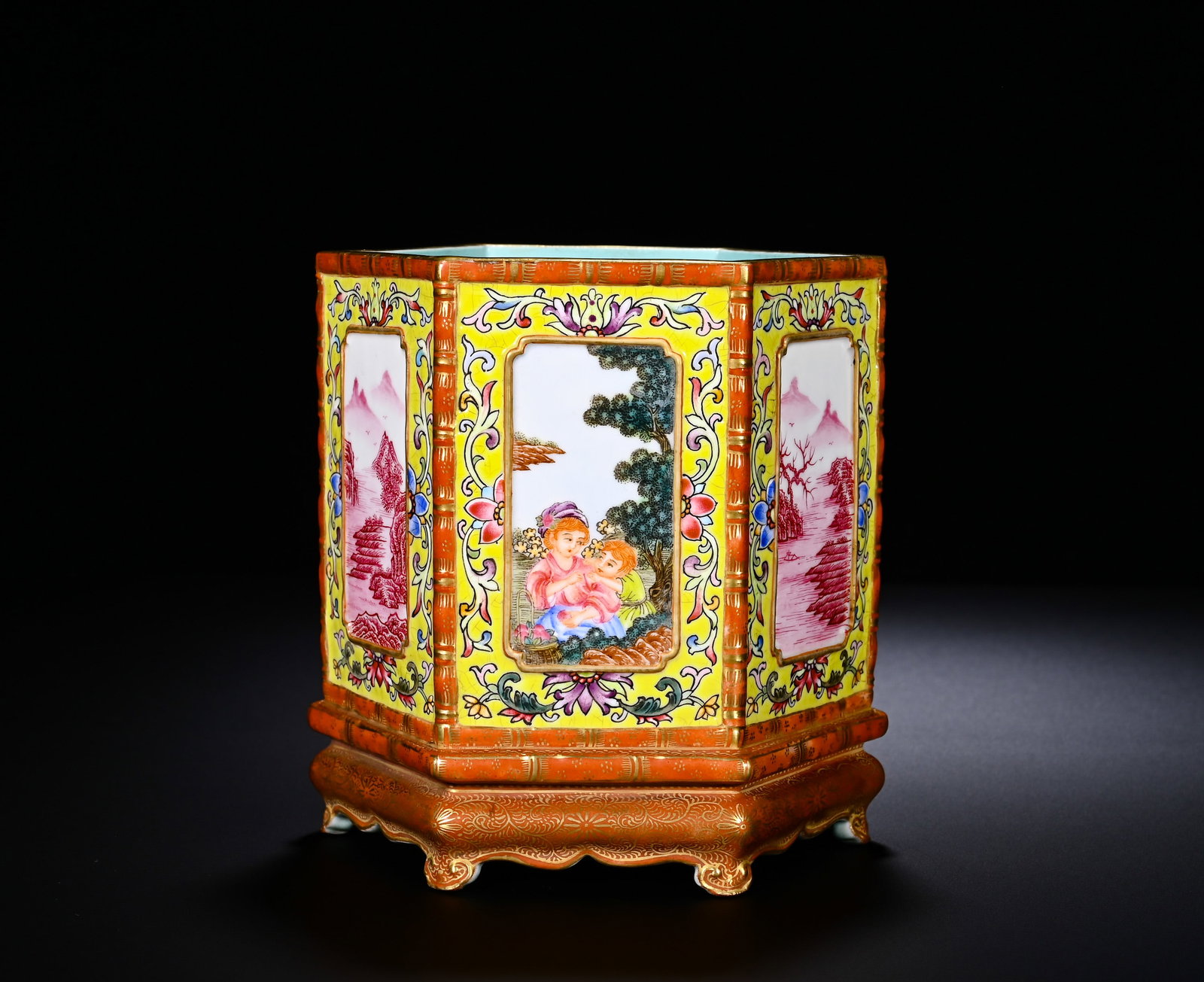 Qing Dynasty, Western Figure Brush Pot with Gilding and Gilding in the Qianlong Period: A Qianlong-period hexagonal brush pot with famille-rose and gilding on yellow ground, featuring western-figure and landscape panels. Hexagonal form with gilded simulated-bamboo base. Bright-yellow gro