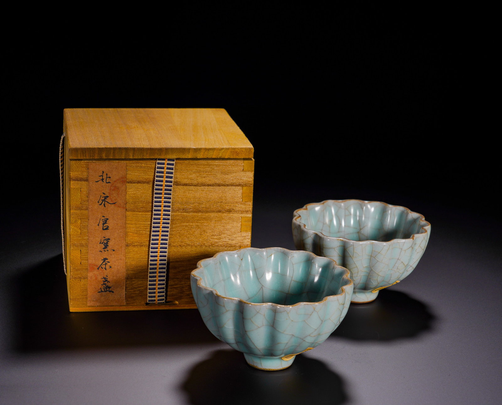 Northern Song Dynasty, Pair of Celadon Glazed Flower-Mouthed Tea Cups Official Kiln: The pair of tea cups are Northern-Song Guan-ware, shaped as lobed flower-form with elegant vertical ribs. The vessels are covered with lustrous sky-celadon glaze, naturally decorated with fine golden-