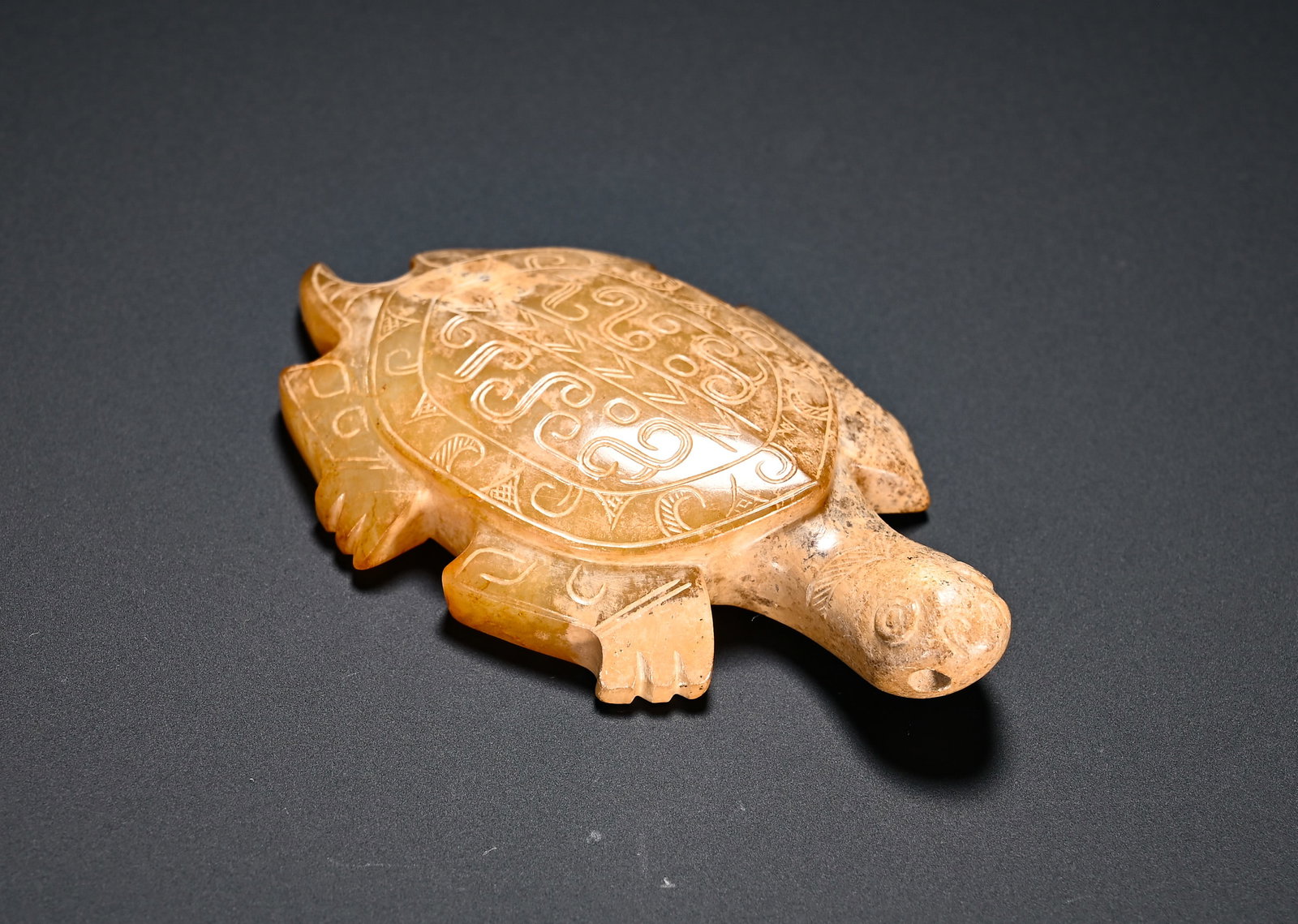 Shang and Zhou Dynasties, Hetian Jade Turtle Pendant: Shang-Zhou Dynasty Hetian jade turtle pendant. The turtle is carved in a prone posture with plump carapace incised with scroll cloud and triangular patterns. The outlines of limbs and head are rendere