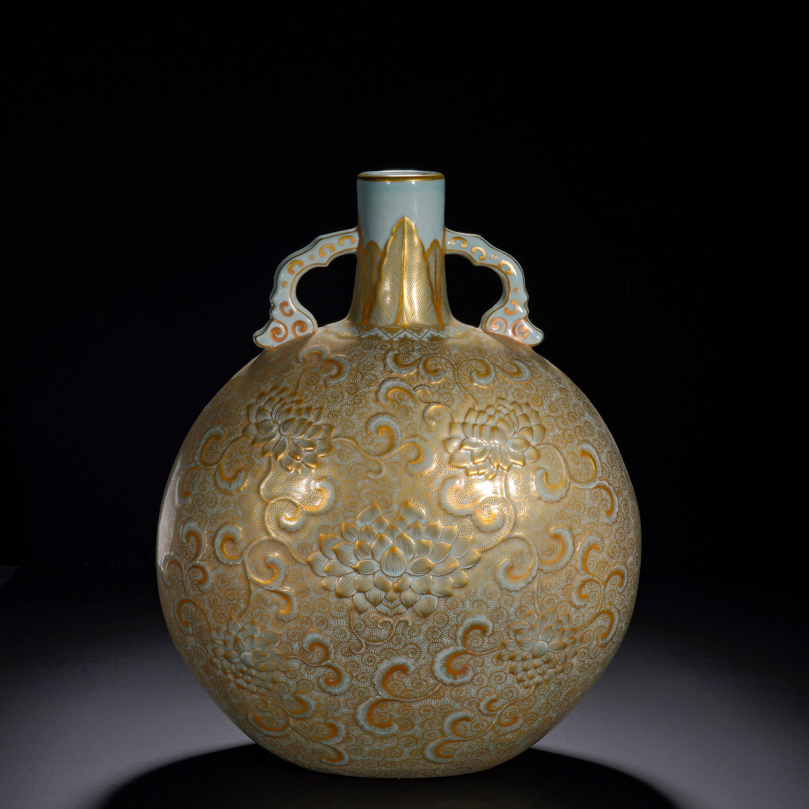 Double-Eared Moon-Holding Vase with a Light Blue Ground, Gilded and Embossed Lotus Pattern: A grand imperial porcelain moon-shaped vase of Yongzheng reign. It has a short straight neck flanked by two ruyi-scroll handles and a large flattened globular body. The whole surface is covered in pal