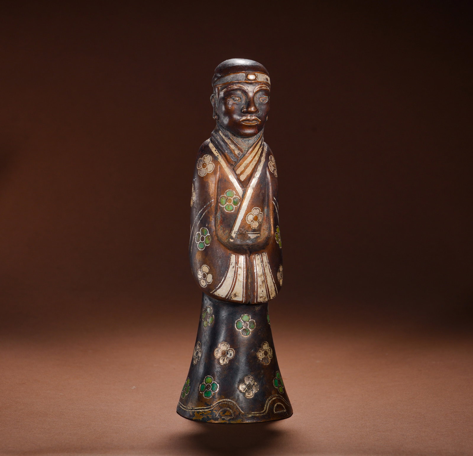 Han Dynasty, Bronze Figure with Inlaid Gold and Silver and Glazed Flower Patterns: Cast bronze standing figurine with headband, cross-collar wide-sleeve robe and flared base. Intricate gold and silver wire outlines diamond frames, inlaid with five-petaled glass flower ornaments all 