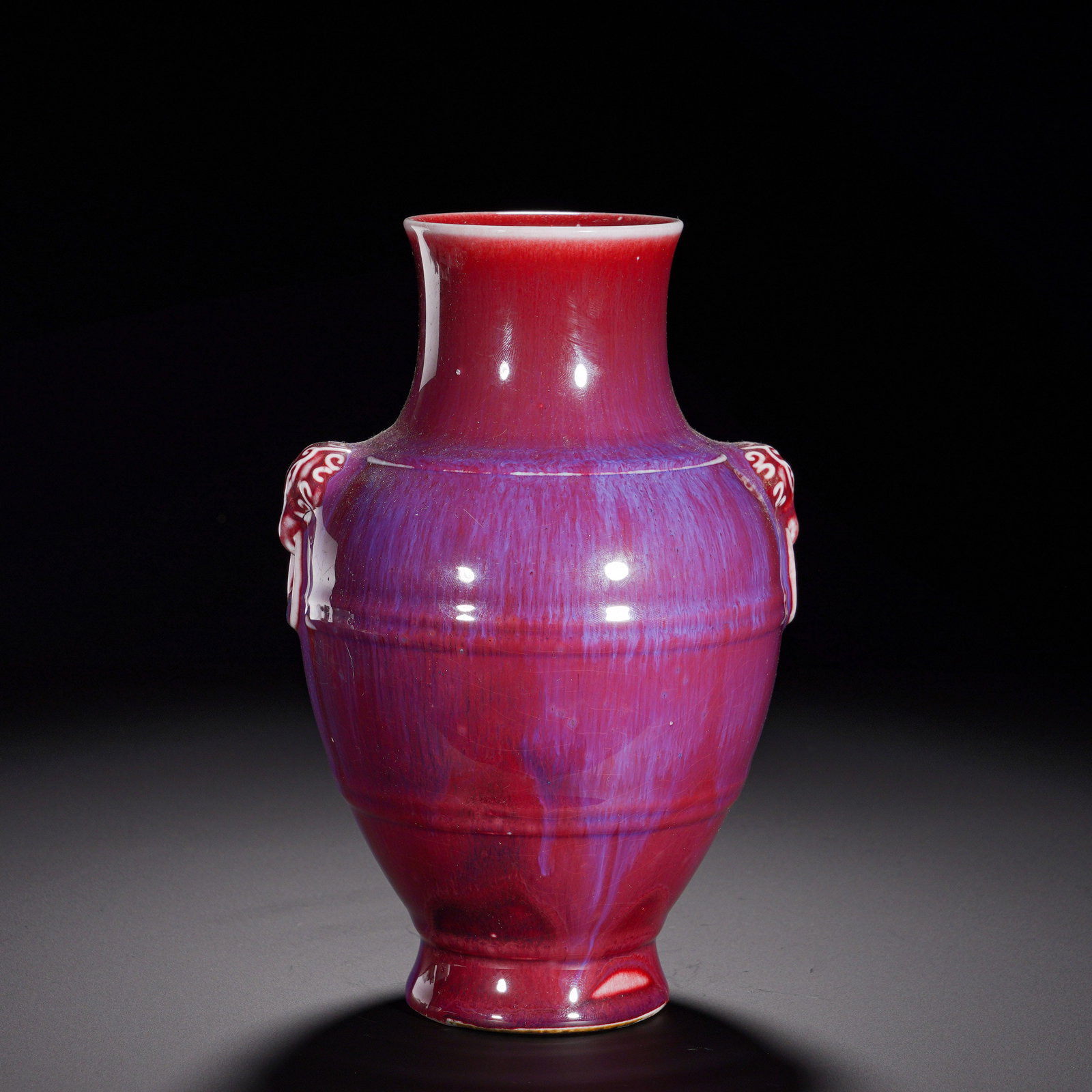 Qing Dynasty, Glazed Beast Ear String Pattern Vase: Zun vase with flared mouth, thick neck, swelling belly and splayed foot. Symmetrical beast-head handles emerge from shoulders, and several raised bow-string ribs decorate the body. The whole piece is 