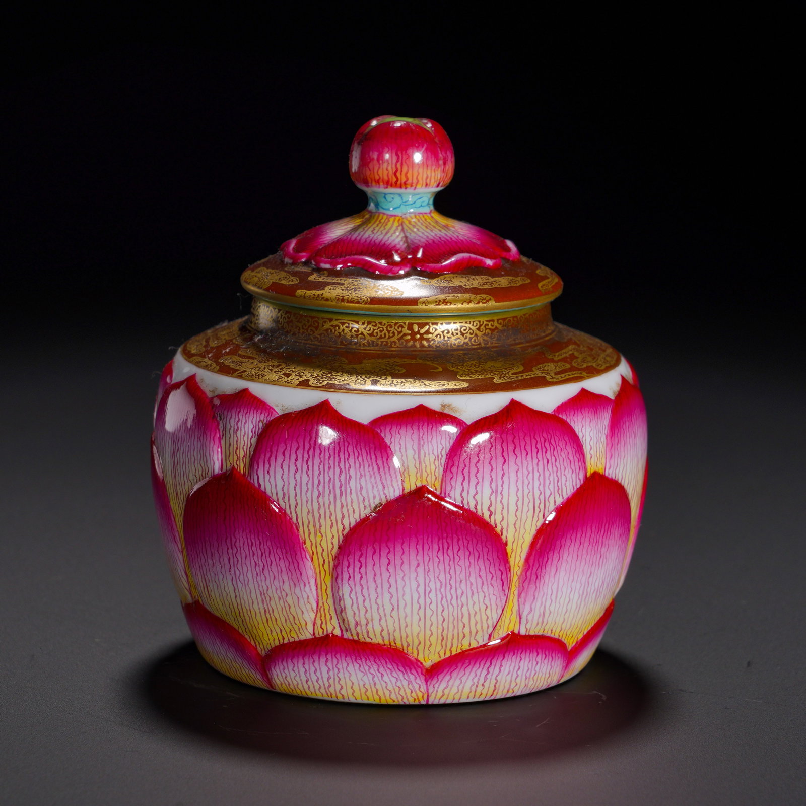 Qing Dynasty, Yongzheng Period, Pastel Relief Lotus Petal Patterned Lid Jar: Lidded jar with contracted mouth, full shoulder, rounded belly and ring foot. The lid is topped with a lotus-bud finial. The whole body is decorated with layered relief-carved lotus petals, colored