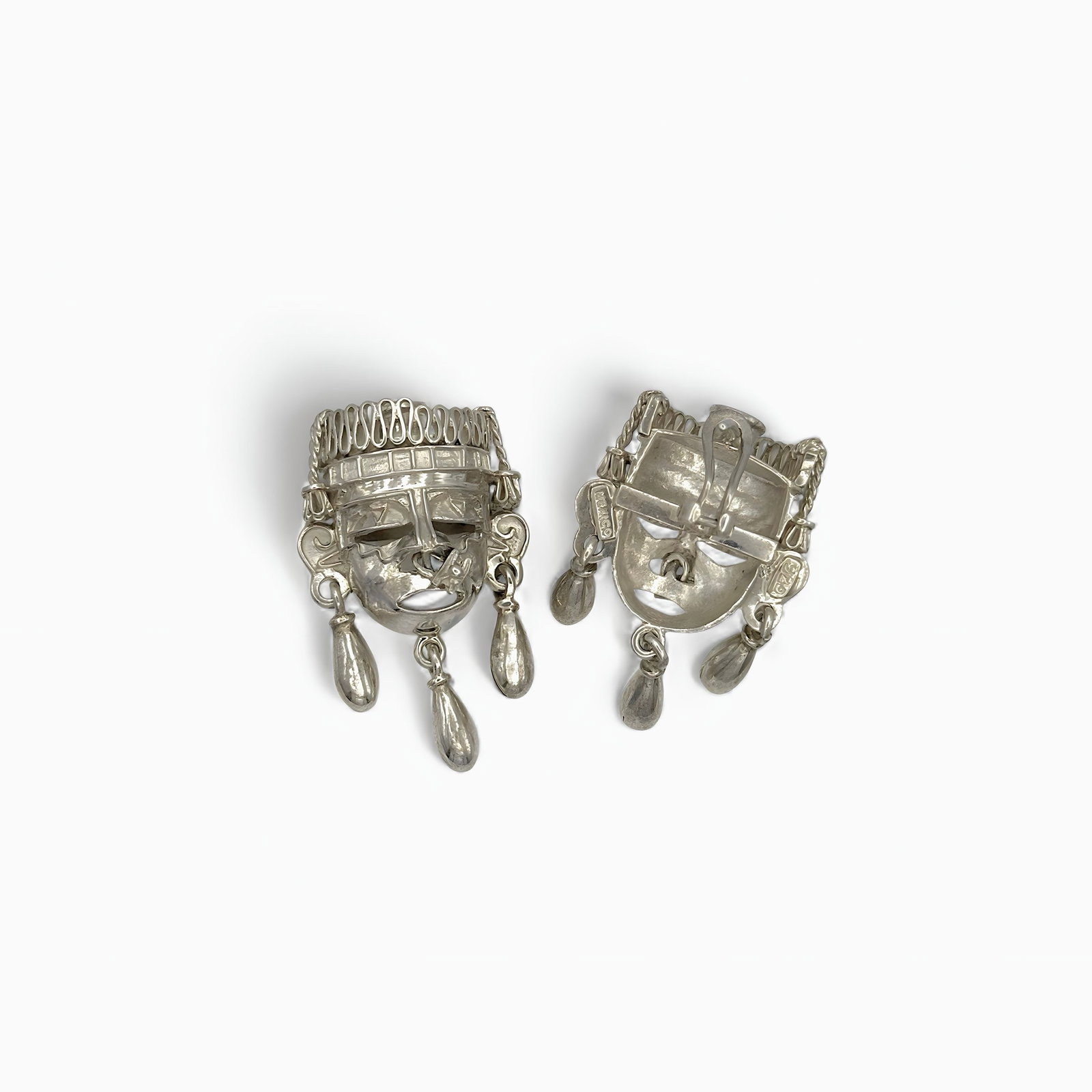 Regal Echoes Earrings Sterling Silver Face: Oro de Monte Albán – Regal Echoes EarringsSterling Silver Face Earrings from Oaxaca, MexicoRooted in the spirit of ancient Mesoamerica, the Regal Echoes Earrings by Oro de Monte Albán channel the 