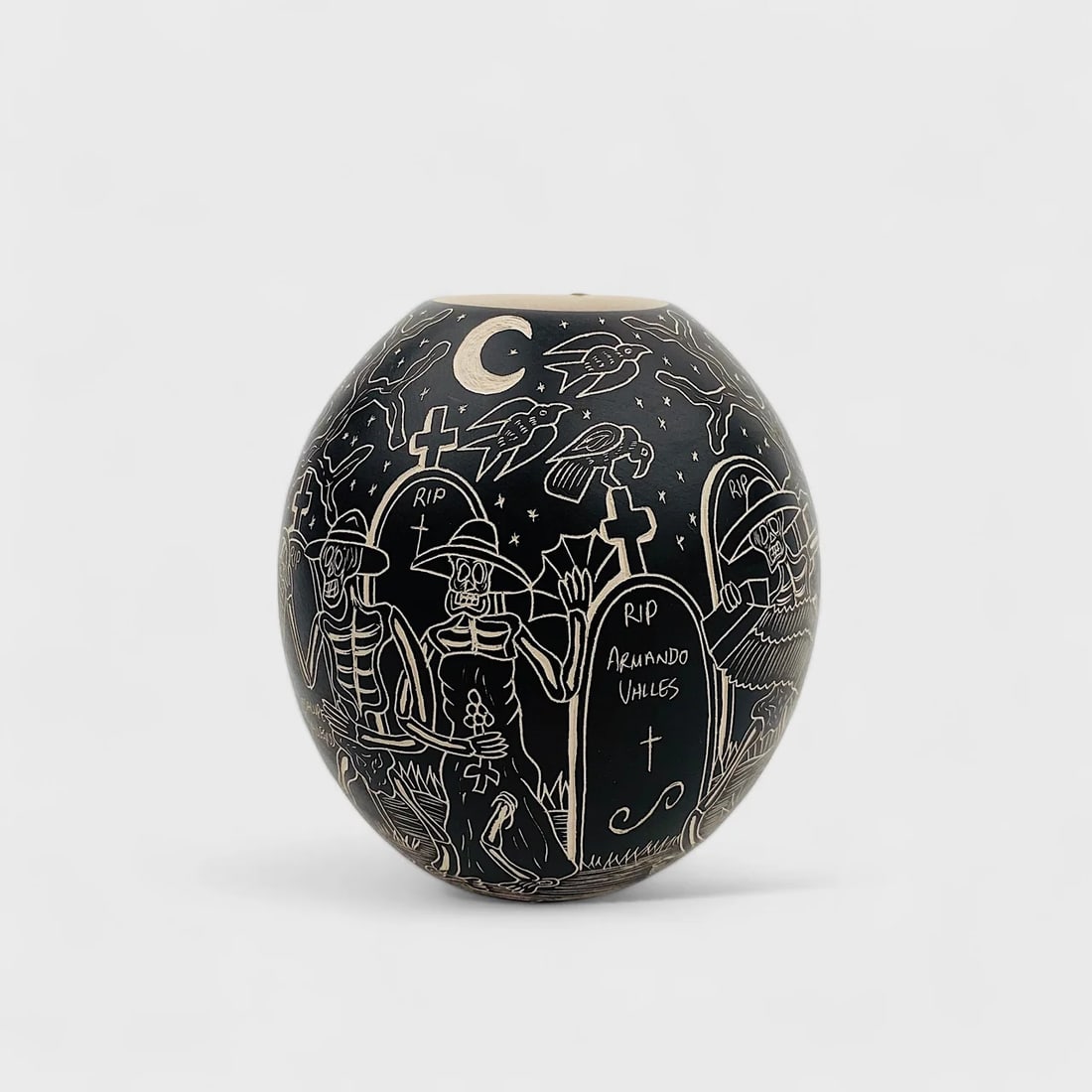 "Night of the Calaveras" Hand-formed Cermaic Vase: Hilario Quezada Night of the Calaveras 5" (h) x 4.5" (w)Weight not Specified.Hand-formed ceramic with etched black matte finish, sgraffito technique. Signed. Echoing the spirit of Día de los Muertos,