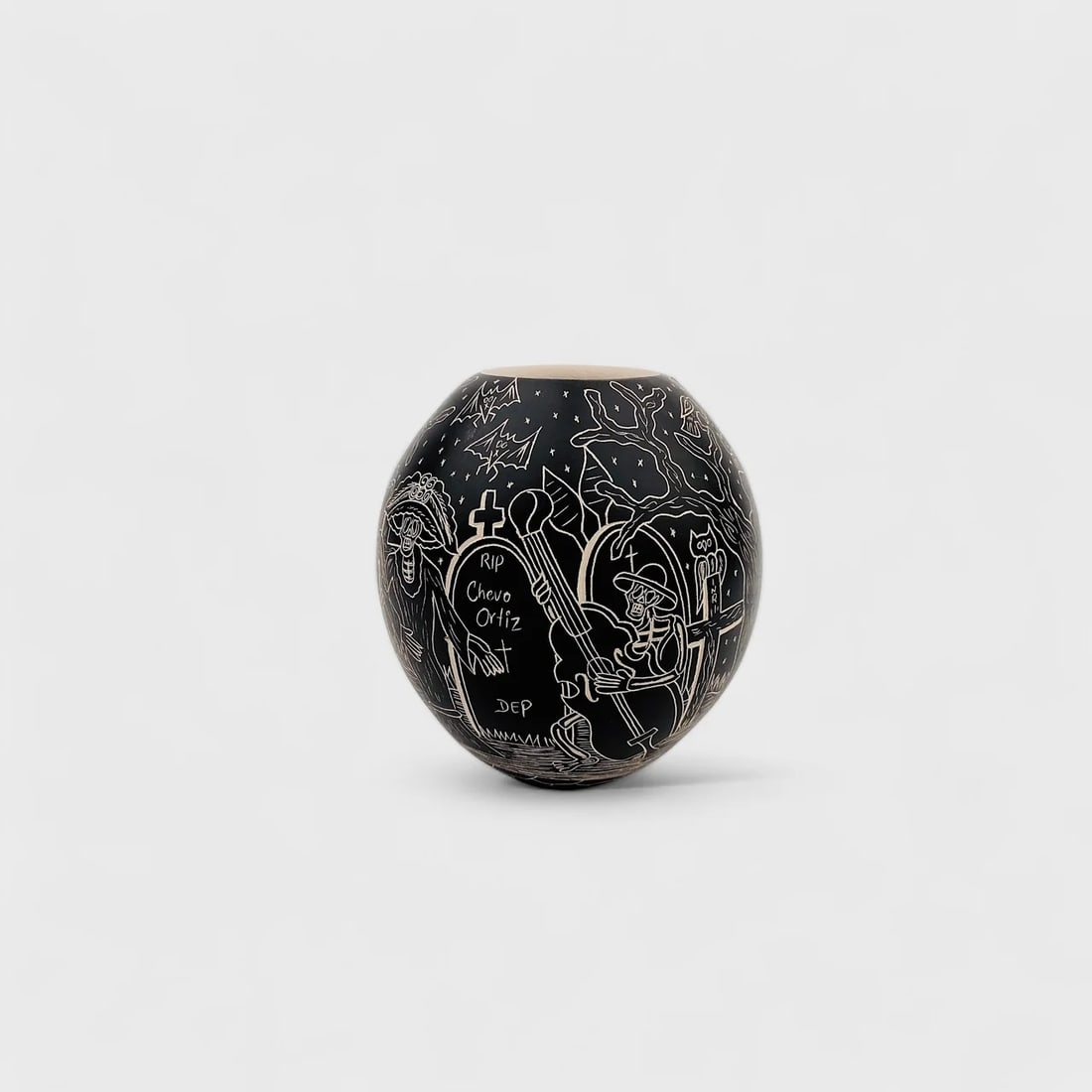 "Midnight Serenade" Hand-formed Cermaic Vase: Hilario Quezada Midnight Serenade Vase5" (h) x 4.5" (w)Weight not Specified.Hand-formed ceramic with etched black matte finish, sgraffito technique. Signed. Dark, playful, and deeply rooted in traditi