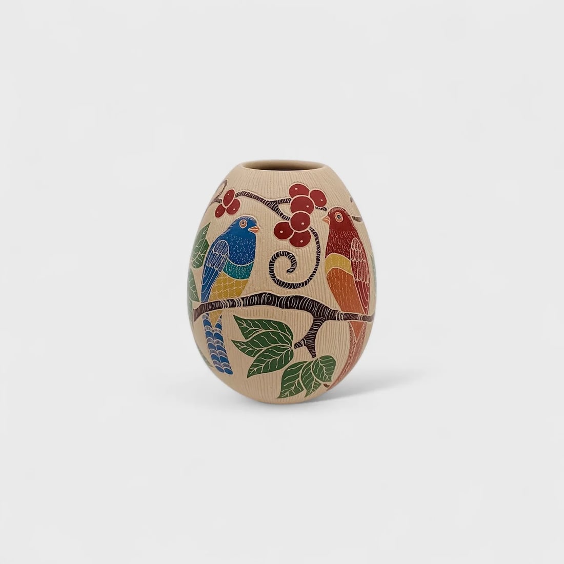 "Songbird Among Berries" Hand-coiled Clay Vase: Guadalupe MendezSongbirds Among Berries4.25" (h) x 3.5" (w)0.5 lbs. Hand-Coiled clay, hand-etched painted with natural pigments. Signed.Songbirds Among Berries by Guadalupe Melendez is a celebration o