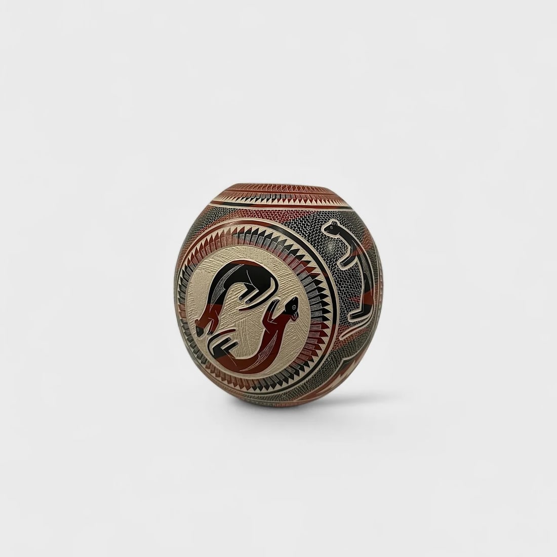 "Twin Otters" Hand-coiled Clay Vase: Jesus Olivas QuintanaTwin Otters 7" (h) x 6.5" (w)1.6 lbs. Hand-coiled clay, sgraffito engraving and hand-painted designs in terracotta, black, and cream tones. Signed. Twin Otter Bowl by Jesús Oliva