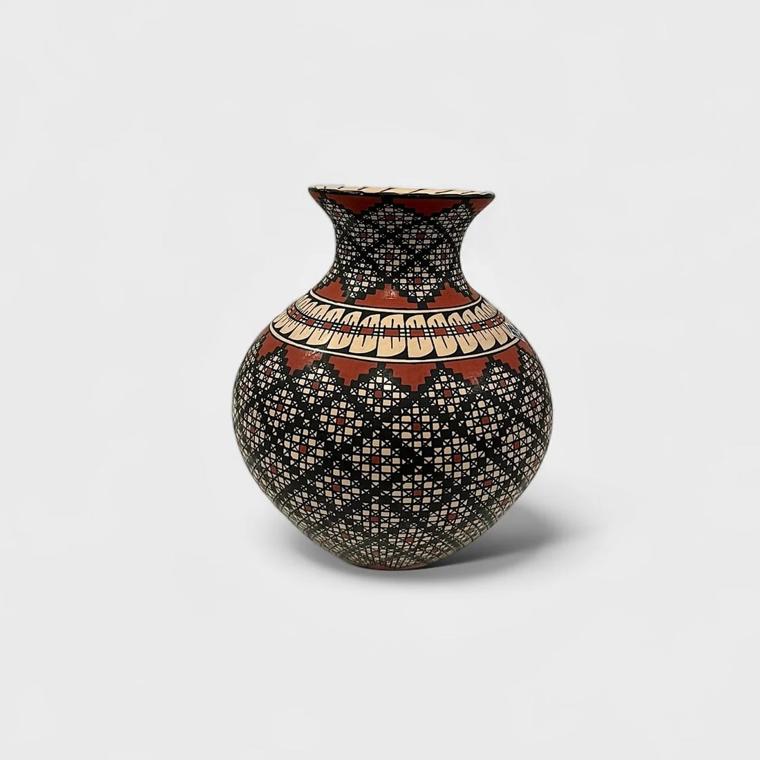 "Infinte Pattern Vase" Hand-coiled Ceramic Vase: Rosa Loya Infinte Pattern Vase 8.5" (h) x 7" (w) 1.8 lbs. Hand-coiled and painted ceramic, intricate black, red, and cream geometric motifs. Signed. A masterclass in precision and symmetry, Infinite P