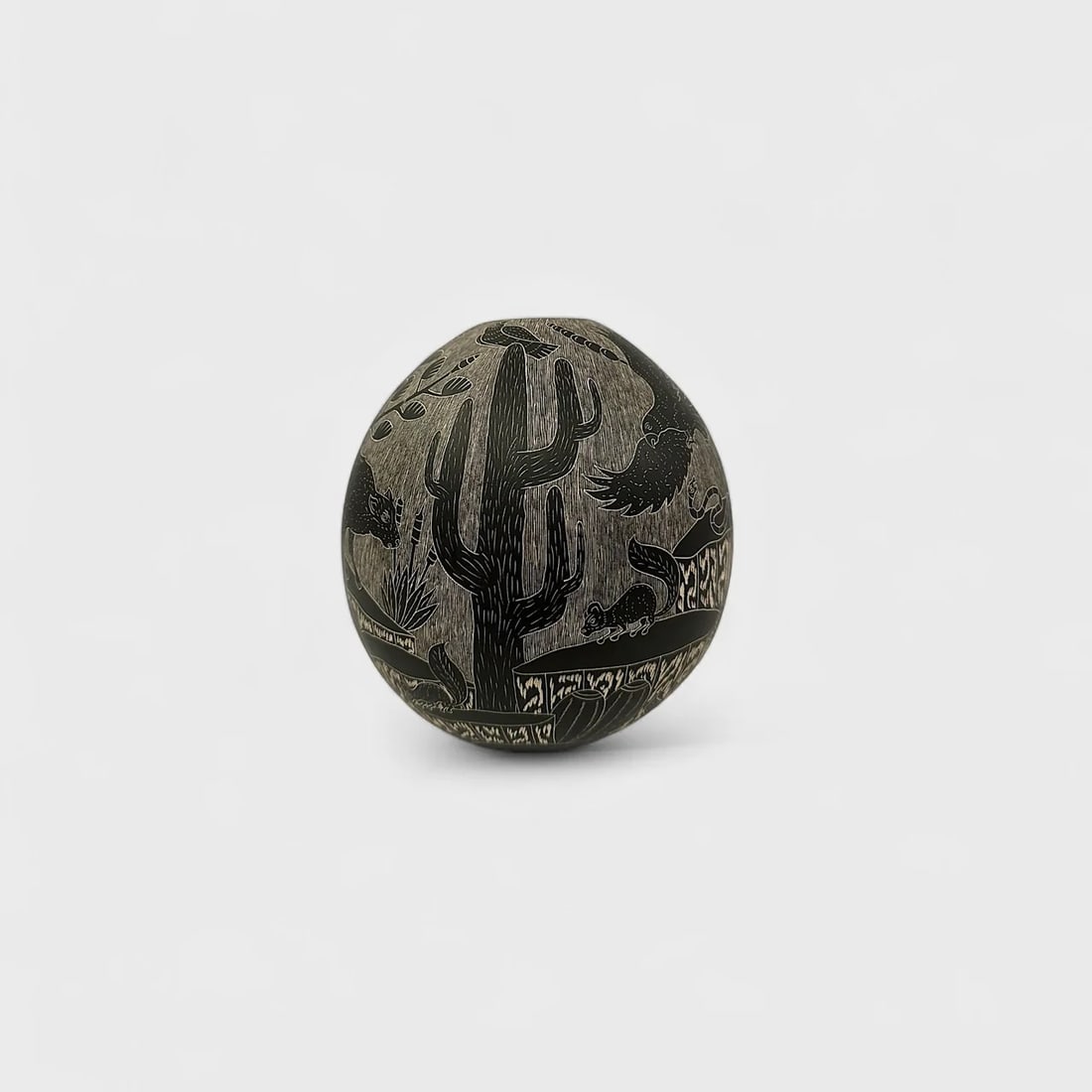 "Shadow in the Creature" Hand-coiled Black Clay Vase: Angel Guerrero Trillo Shadow Creatures7" (h) x 6.5" (w)1.6 lbs. Hand-coiled black clay, etched motifs in white linework. Signed. Shadow Creatures by ?ngel Guerrero Trillo transforms a black clay vesse