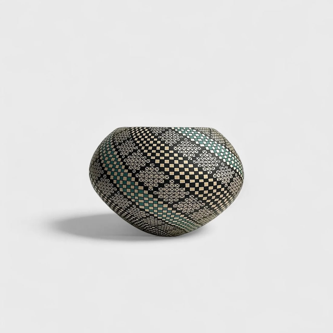 "Illusion Grid" Hand-coiled Clay Vase: Cristina Acosta Illusion Grid 5" (h) x 5.5" (l)3 lbs. Hand-coiled clay hand-painted geometric pattern in black, cream, and teal matter finish. Signed. Illusion Grid by Cristina Acosta is a masterstrok