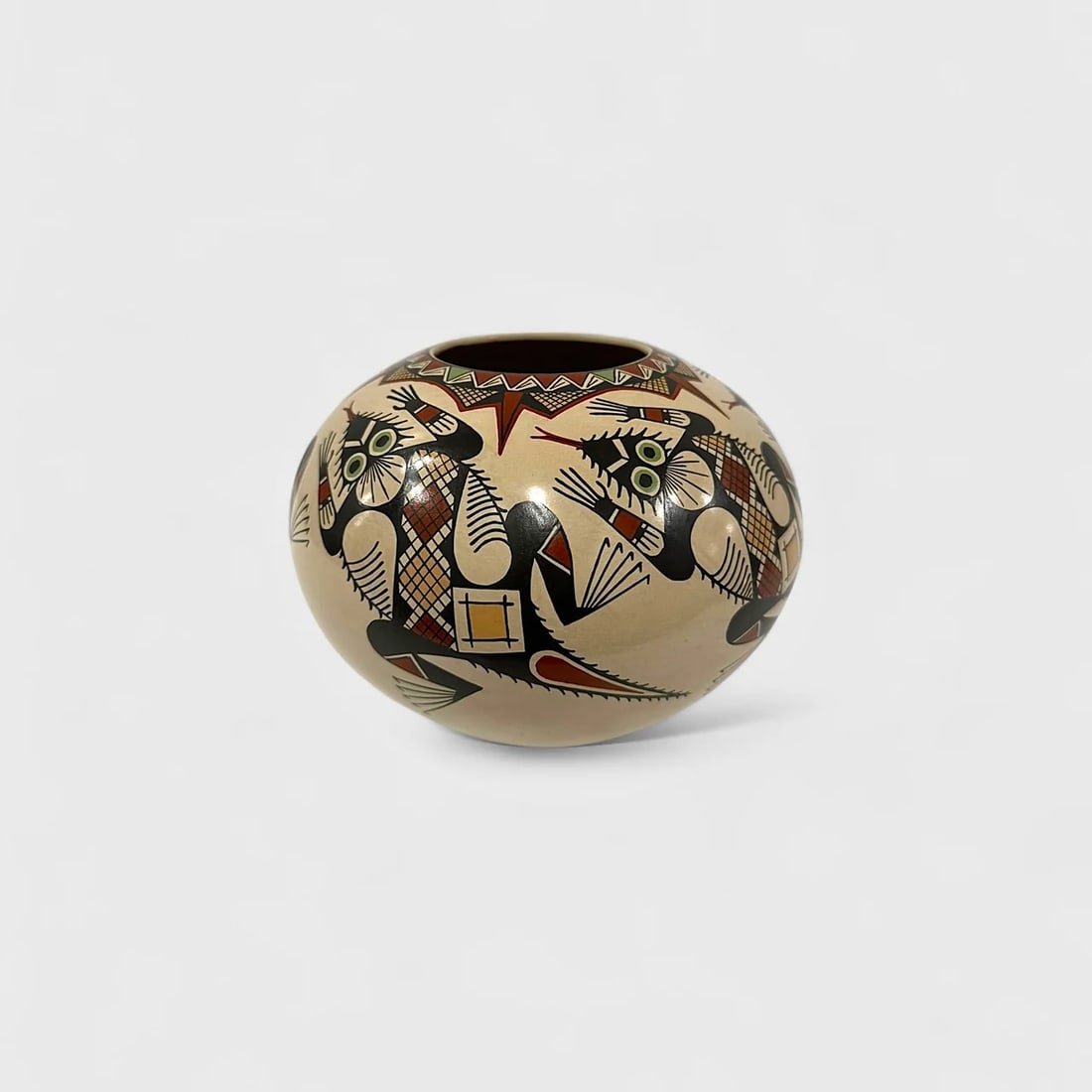 "Eyes of the Desert" Hand-coiled Ceramic Vase: Roberto Bañuelos Eyes of the Desert6" (h) x 7" (w)Weight not Specified. Hand-coiled ceramic, hand-painted surface with abstract motifs and geometric detailing. Eyes of the Desert by Roberto Bañuelos