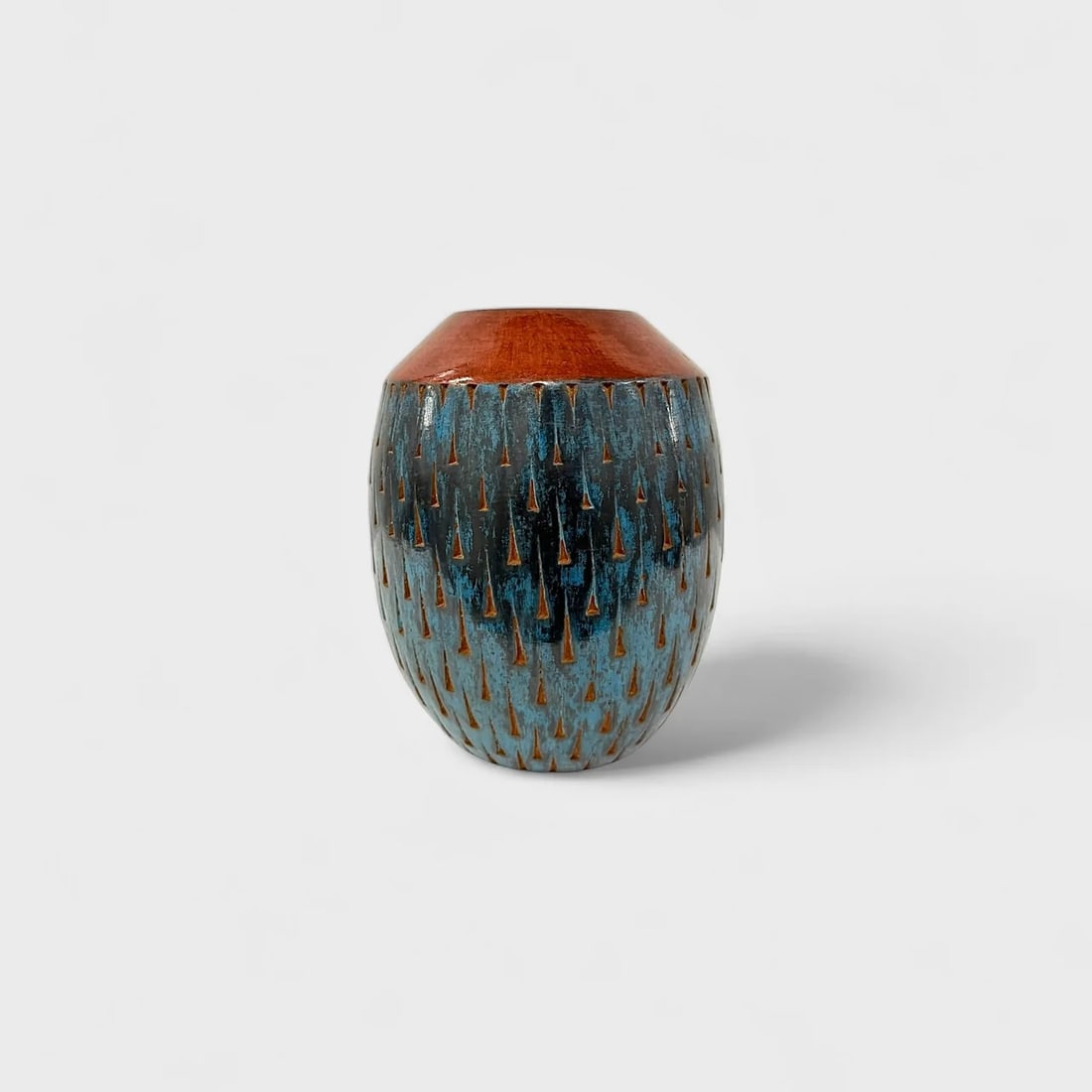 "Rainfall in Earth and Sky" Hand-coiled Clay Vase: Aydee Rodriguez Lopez Rainfall in Earth and Sky9" (h) x 7" (w)4.6 lbs. Handcrafted and burnished clay, blue and brown finish with etched design. Signed. Combining elegant form with ancestral technique