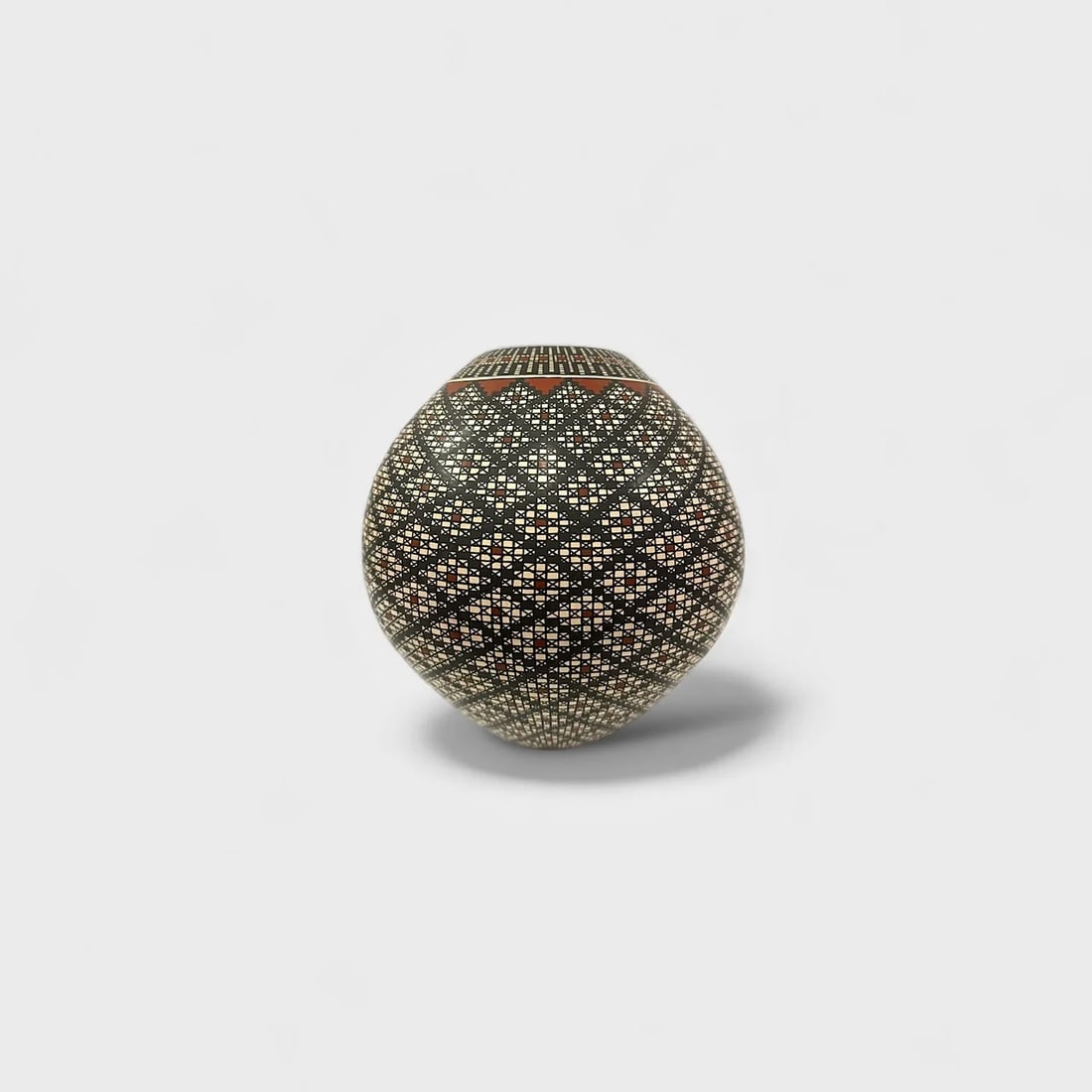 "Diamond Weave" Hand-coiled Clay Vase: Ernesto Arras Olivas Diamond Weave 10.5" (h) x 9.5" (w)3.2 lbs. Hand-coiled ceramic with intricate diamond etching and color accents. A mesmerizing study in repetition and symmetry, Diamond Weave by E