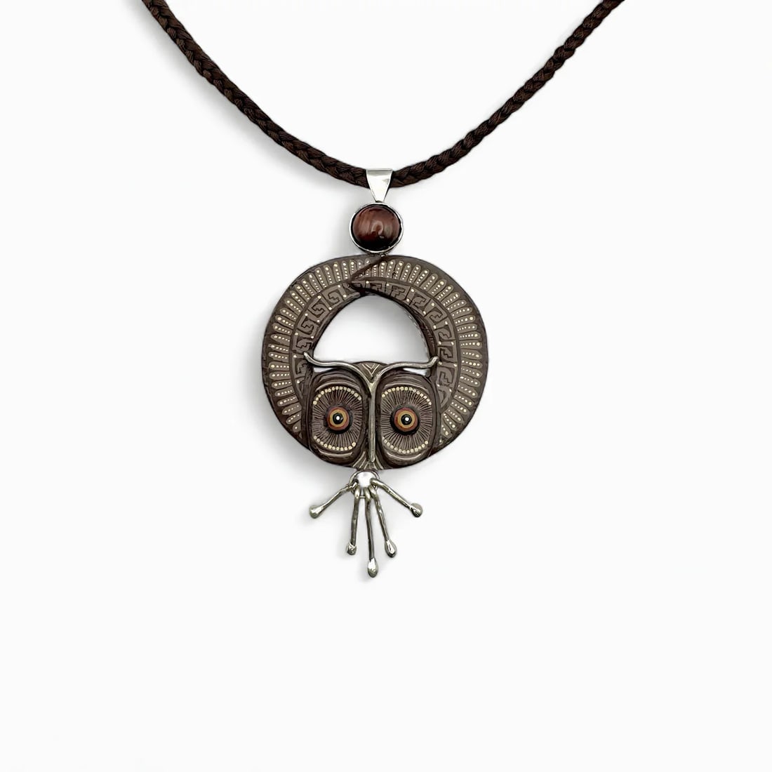 "Night Watcher II" Zapotec Necklace: Striking in form and meaning, Night Watcher embodies the mysticism of Zapotec symbolism through the form of a watchful owl. Expertly hand-carved from copal wood and set within a sterling silver frame,