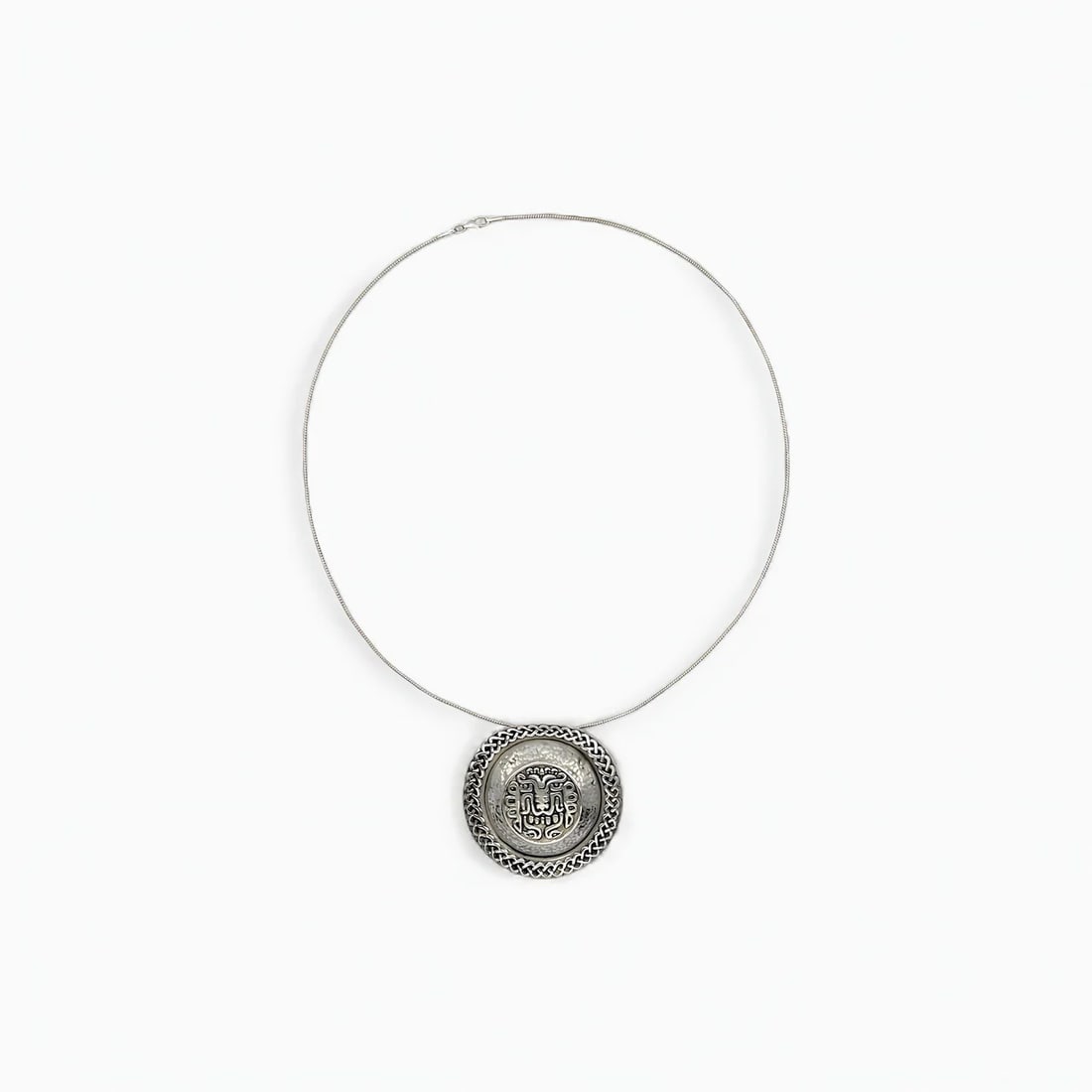 "Royal Echoes" Peruvian Necklace: A regal tribute to ancient power, Royal Echoes centers on a bold, circular pendant inspired by the funerary rattles of the legendary "Señor de Sipán." Crafted entirely from silver, the design featur