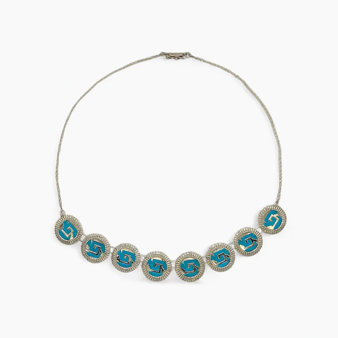 "Chimalli Guard" Columbian Turquoise Necklace: Inspired by the strength and geometry of ancient warrior shields, the Chimalli Guard Necklace by Oro de Monte Albán features a rhythmic arrangement of circular medallions, each set with a vibrant tur