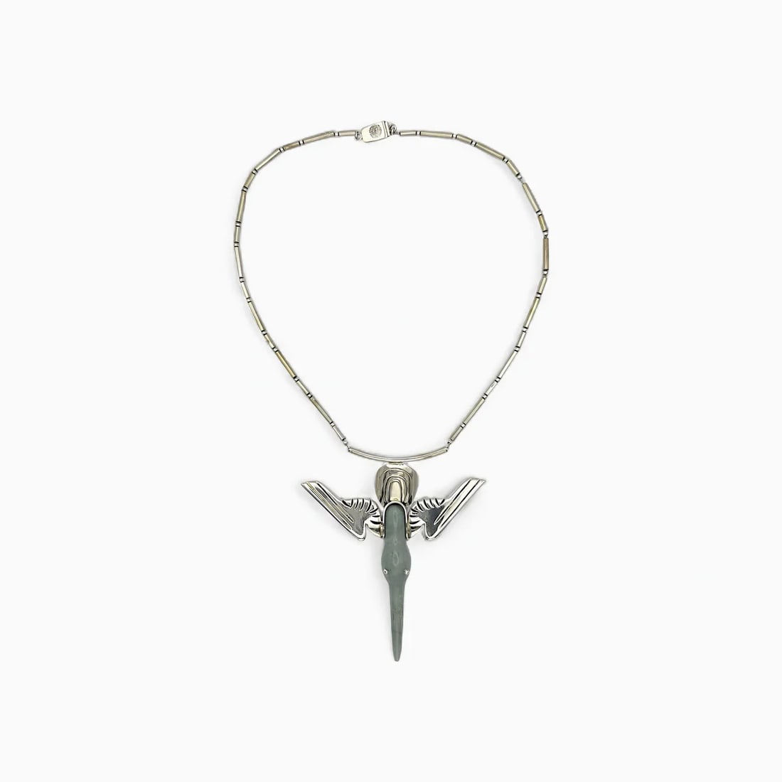 "Hummingbird" Carved Jade Necklace: One of William Spratling’s most refined authorized replicas, the Hummingbird Necklace draws from both natural symbolism and Mesoamerican materials. The pendant features an elegant jade carving shape