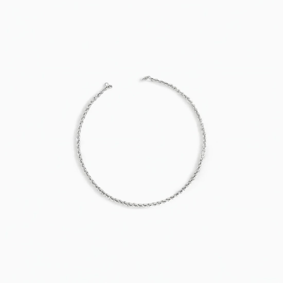 "Infinity Link" Necklace: Exuding timeless elegance, this Casa TANE necklace features a fluid sequence of infinity-shaped links, each meticulously forged from sterling silver. The polished finish enhances the rhythmic