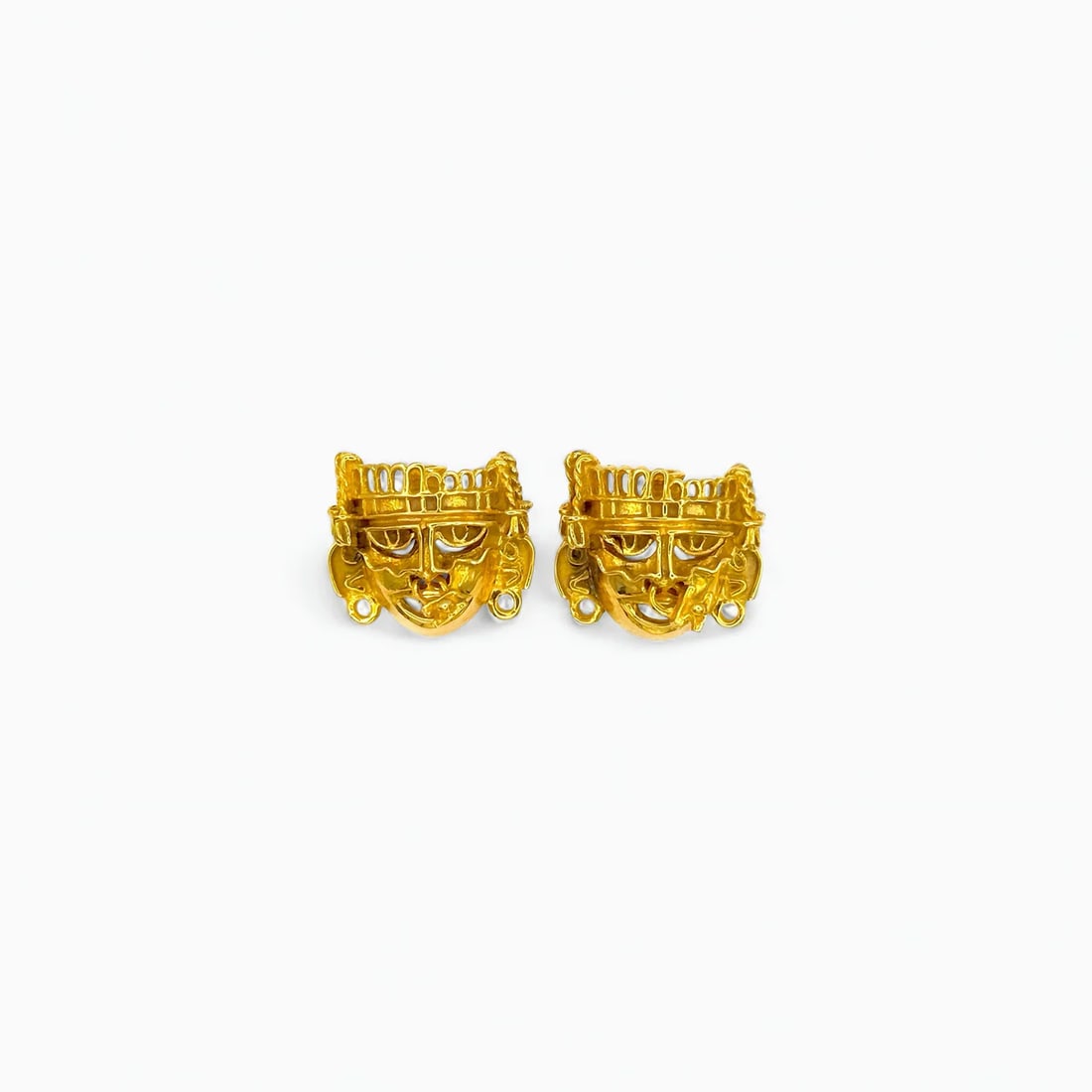 "Divine Visage" 14K Gold Earrings: These striking earrings depict the stylized face of a pre-Hispanic deity, a design rooted in the iconography of Mesoamerican temple carvings. Forged in rich 14k gold, each face captures a sense of