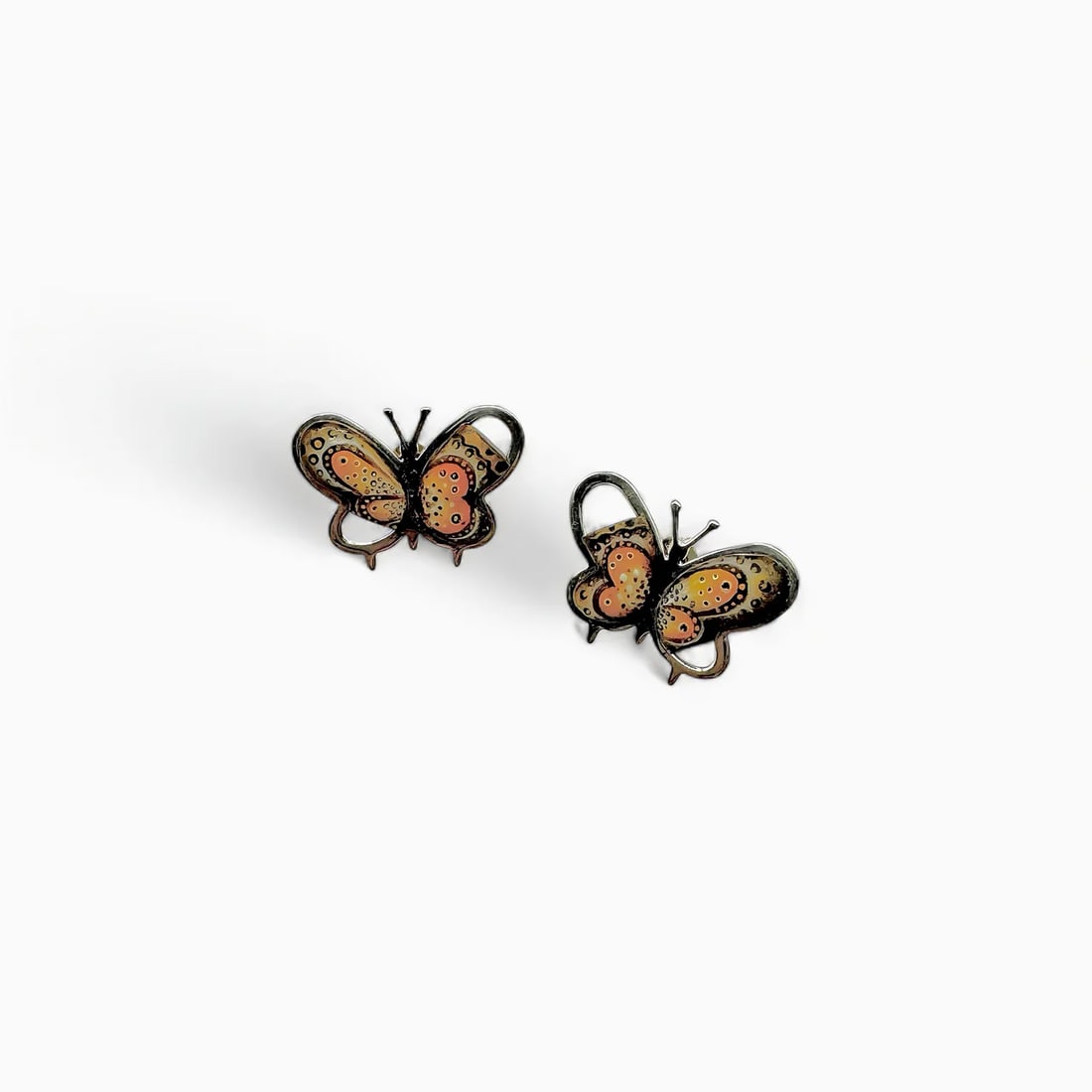"Wings of Ademira: The Painted Butterfly" Earrings: Light, radiant, and richly detailed, Wings of Ademira captures the beauty of butterflies mid-flight. These vibrant earrings are cast in 925 sterling silver and hand-painted with resin in warm hues of
