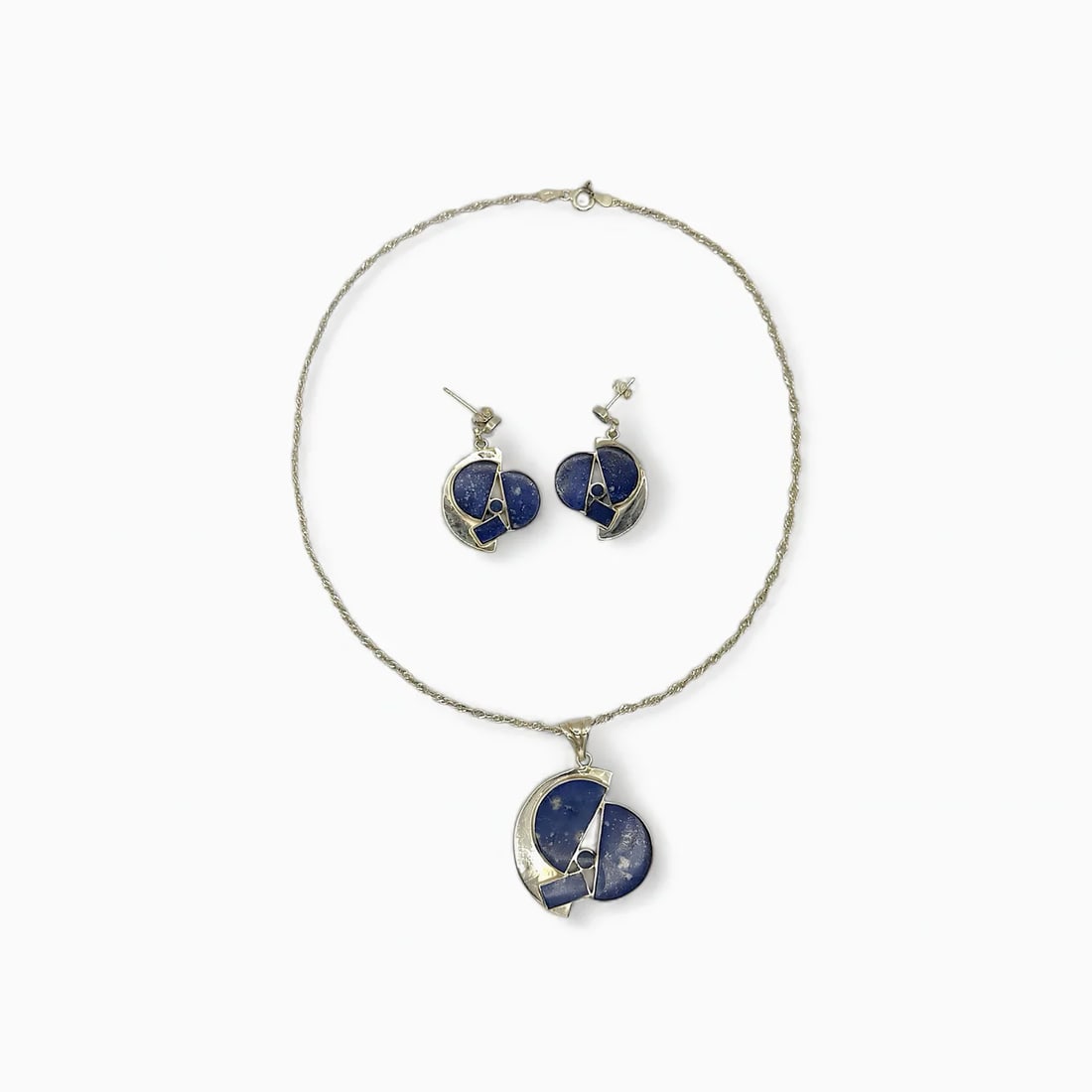 "Celestial Eclipse" Chilean Lapis Lazuli Necklace & Earring Jewelry Set: Inspired by the mystery of the cosmos, this handcrafted set by Chilean artisan Victor Hugo blends geometric abstraction with celestial symbolism. The matching necklace and earrings feature