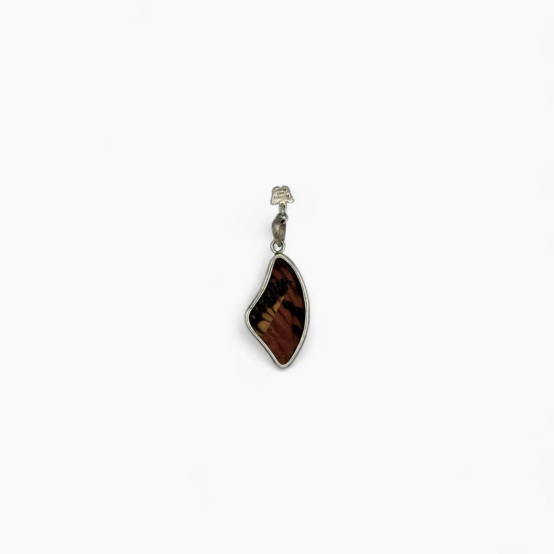 "Earthtone Swirl" Small Butterfly Wing Jewelry Pendant: This medium-sized pendant by Yolanda Ormachea features a beautifully curved frame that mirrors the natural, asymmetrical contours of the butterfly wing it encases. One side displays a deep amber and b