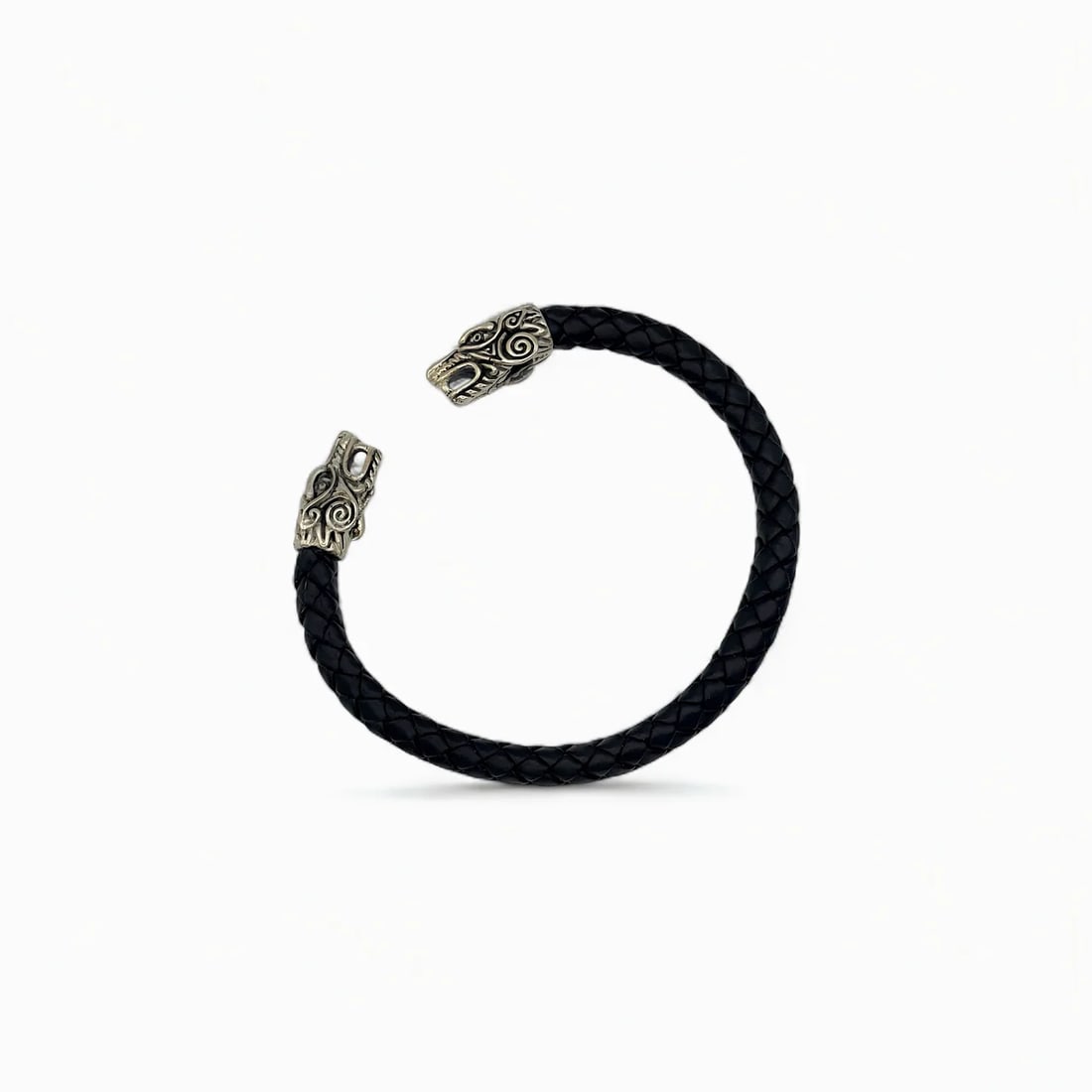 "Guardian Eagle Spirit" Bracelet: This handcrafted cuff bracelet combines modern craftsmanship with ancestral symbolism. The braided black leather band is crowned by two detailed eagle heads rendered in sterling silver, each adorned w