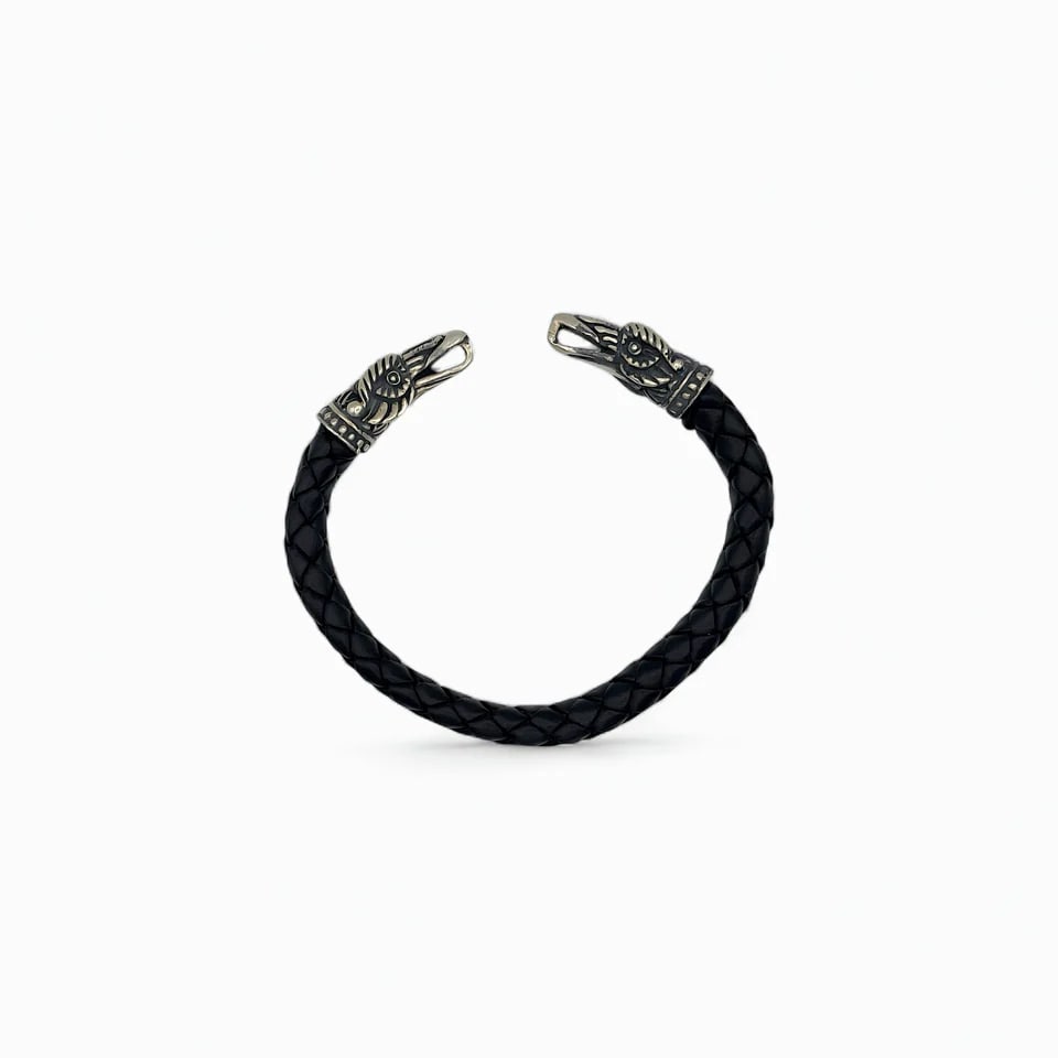 "Twin Eagle Spirit" Bracelet: Strength and symbolism converge in this bold bracelet featuring twin eagle heads, each cast in detailed sterling silver. The black braided leather band offers a striking contrast, grounding the piece 