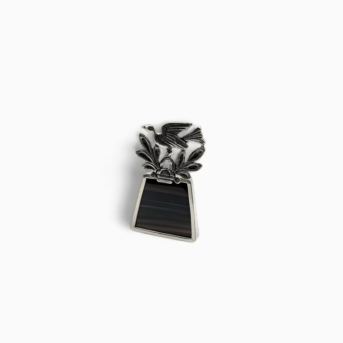 "Bird with Trapezoid Pin" Black Onyx Stone Jewelry Brooch: This distinctive brooch by Ciec-Sipán combines geometric precision with naturalistic elegance. The upper half features a beautifully sculpted bird perched among finely chased leaves, its wings extend