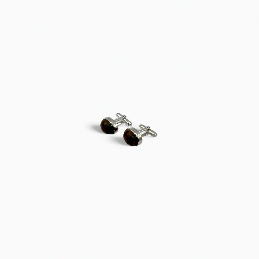 Oval Polished Amber Cufflinks: With rich warmth and understated elegance, these oval cufflinks by Larimar Factory feature polished amber in a classic silver setting. The natural amber’s deep honey tones offer a subtle iridescence