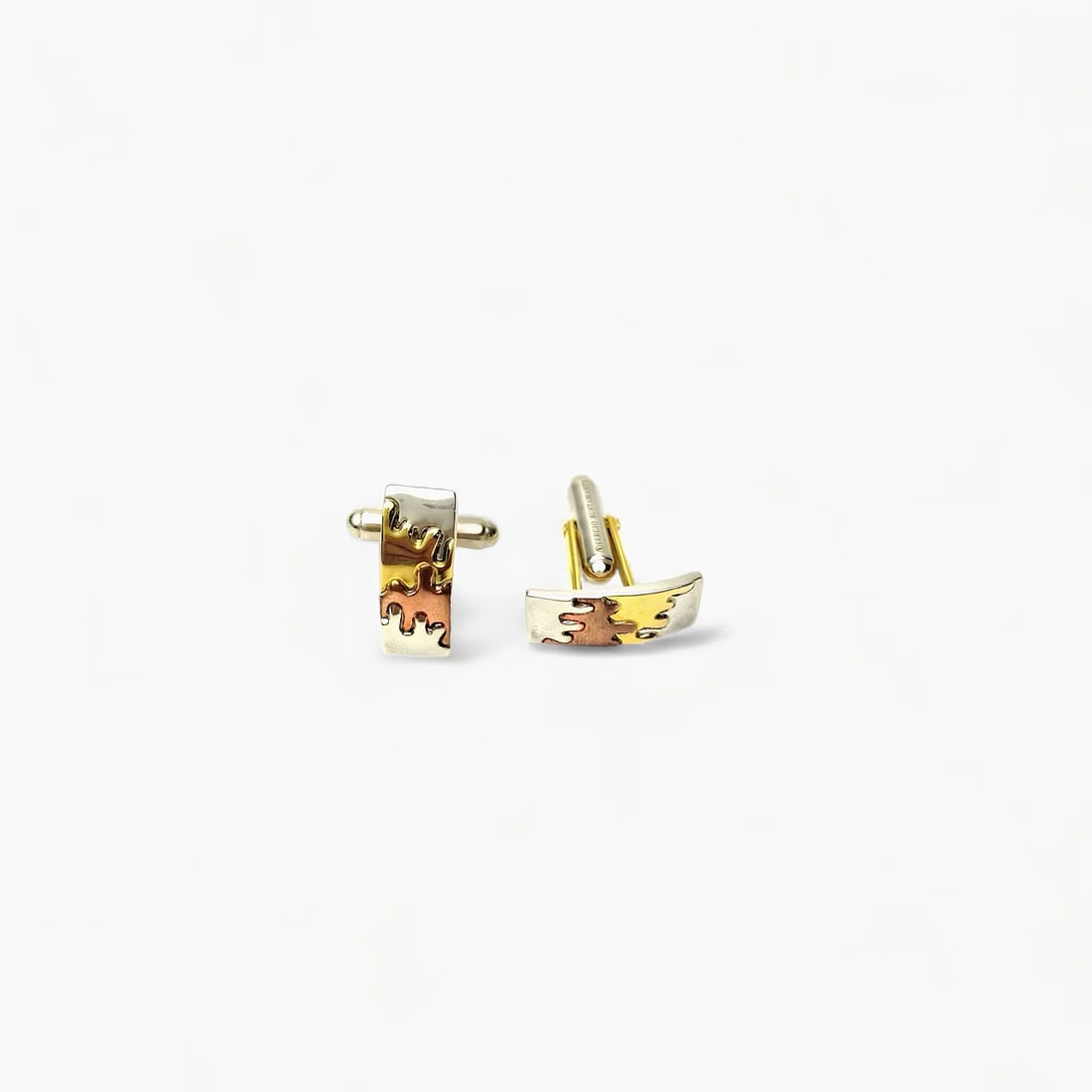 "Tideforms: The Waves" 22K Gold Cufflinks: With undulating, abstract wave motifs in sterling silver and 22k gold plate, Tideforms by Sergio Bustamante turns a classic accessory into a work of wearable sculpture. These cufflinks feature a dual-