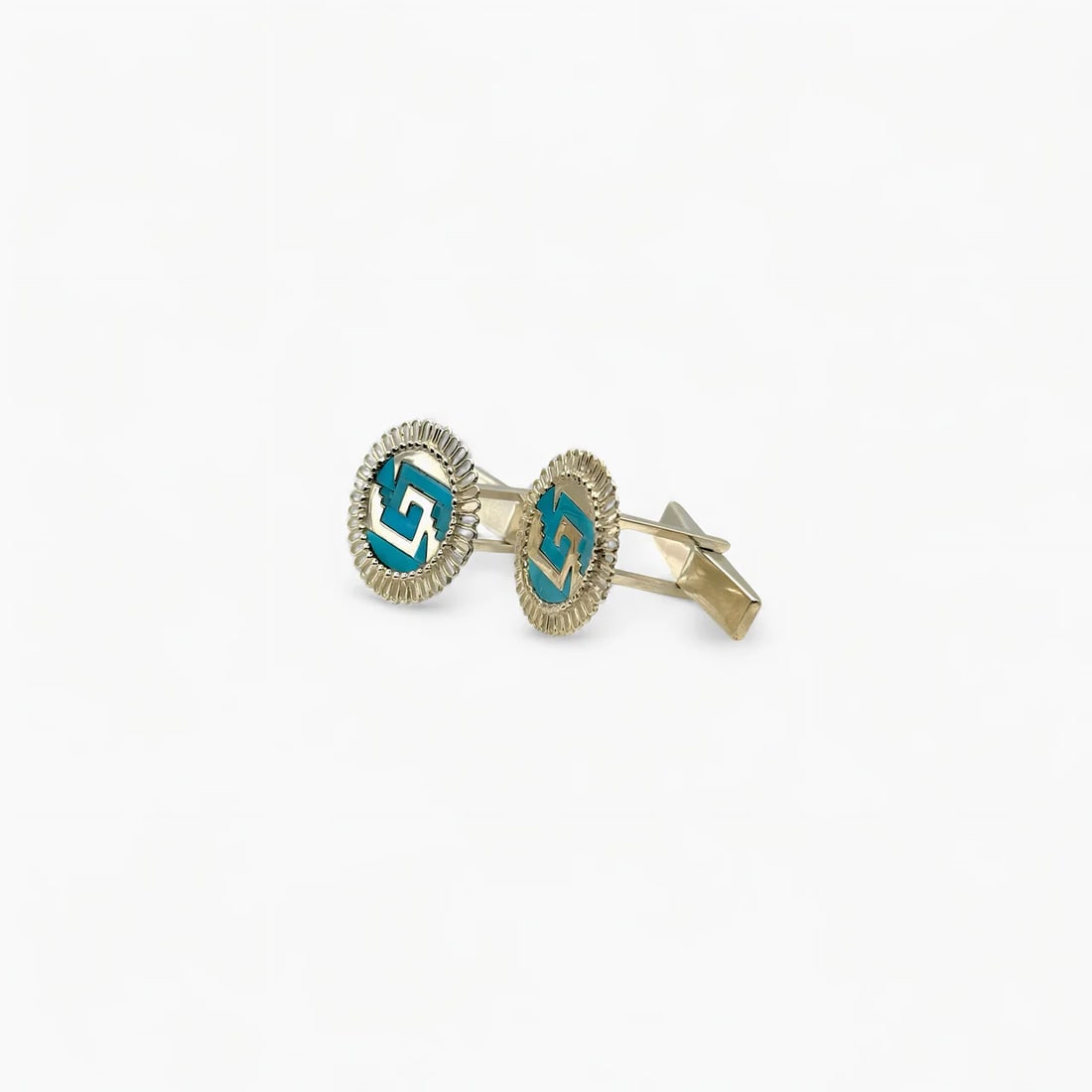 "Chimalli" Turquoise Cufflinks: These round Chimalli Cufflinks by Oro de Monte Albán showcase a refined interpretation of the Mesoamerican chimalli, or warrior shield. Crafted in sterling silver with a brilliant inlay of turquoise,