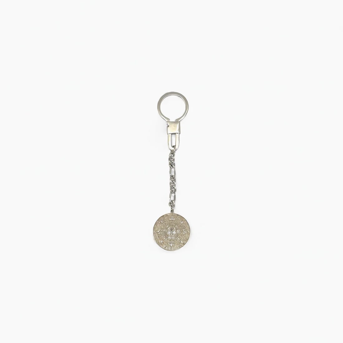"Aztec Calendar lI" Keychain: A symbol of ancient precision and cosmic order, the Aztec Calendar Keychain by Oro de Monte Albán brings the grandeur of Mesoamerican timekeeping to your everyday essentials. Cast in sterling silver,