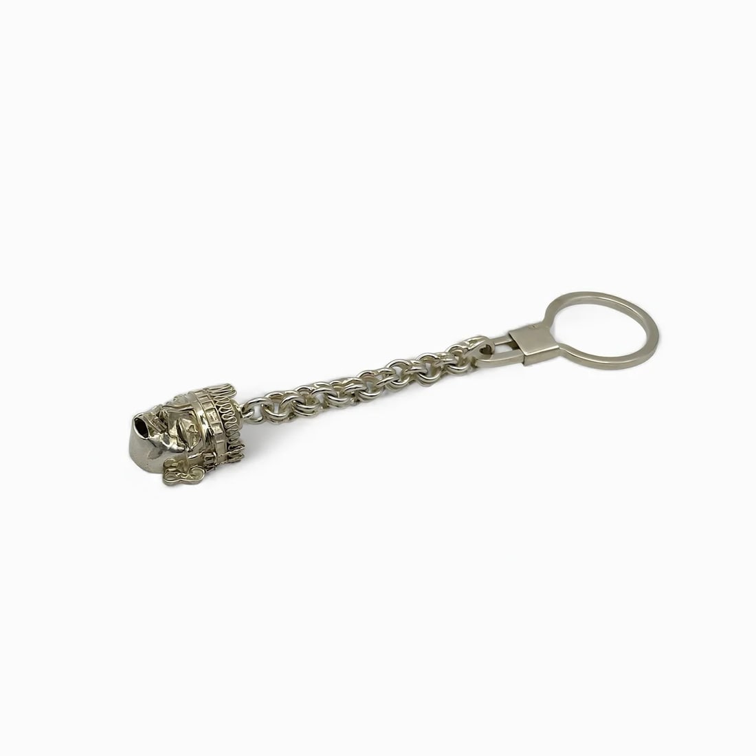 "Big Face II" Columbian Mask Keychain: Both sculptural and symbolic, the Big Face Keychain by Oro de Monte Albán brings ancient character into your daily routine. Handcrafted in sterling silver, the bold face design draws from pre-Columbi