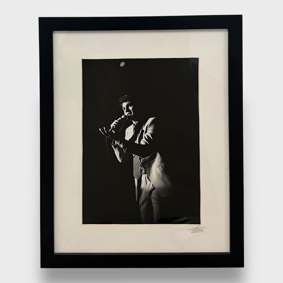 "The Idol - Portrait of Juan Gabriel" Framed Photograph: Juan Ponce Guadián "The Idol" - Portrait of Juan Gabriel Frame: 21.5" x 17.5"Photograph / Digital print from the original negative.Iconic and intimate, The Idol is a signed portrait of legendary