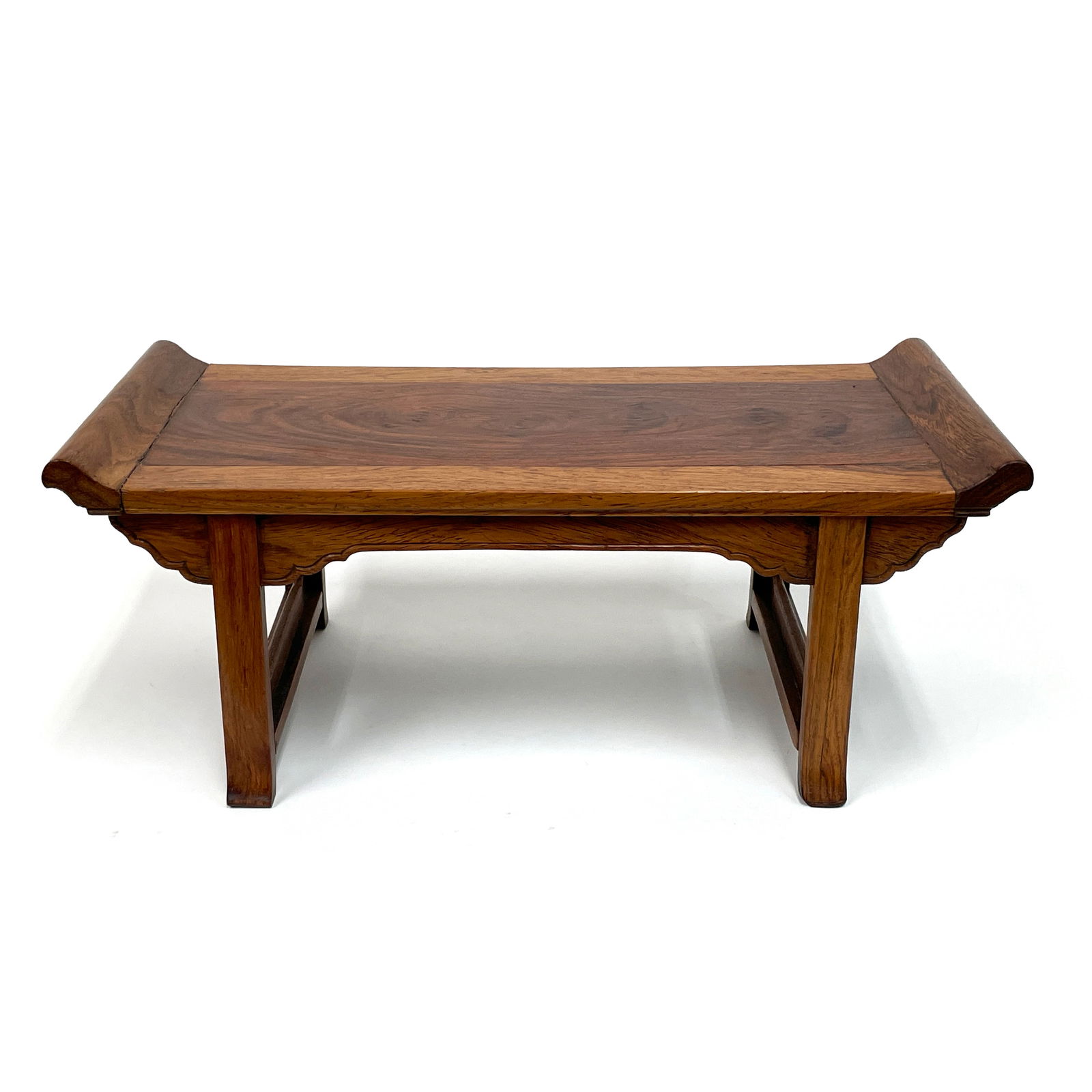 A Miniature Huanghuali Recessed-leg Table, Qiaotouan, late 18th/ early 19th Century: Chinese Scholar Object – A Miniature Huanghuali Recessed-leg Table, Qiaotouan (翘头案), late 18 early 19th Century Crafted from prized huanghuali wood, this exquisite miniature tab