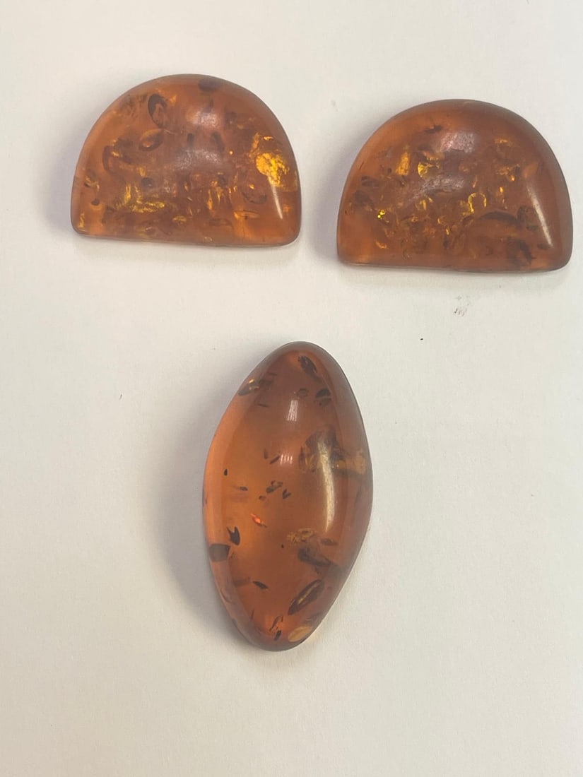 Set Of 3 Loose Amber: Set of 3 genuine natural amber. Each piece contains visible fossil inclusions. Rich, warm color with natural clarity. Unique and naturally preserved pieces.