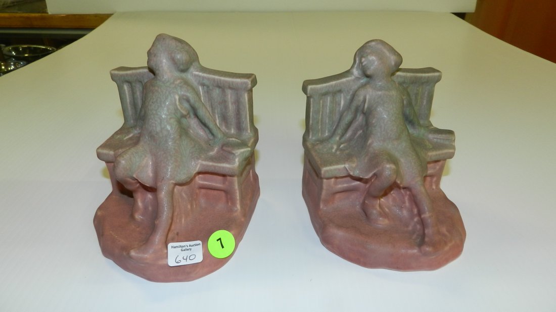 Rookwood bookends w/ young girl on bench w/ a book in m: Rookwood bookends w/ young girl on bench w/ a book in mauve / green glaze, 2446 1922, ht. 5 1/2 in. , In the form of a young girl leaning on a bench with a book in blue / green glaze, with pottery and