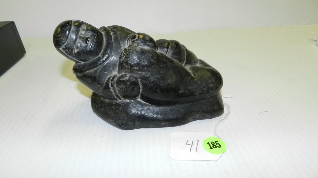 Inuit Steatite carving of man and walrus signed, figure: Inuit Steatite carving of man and walrus signed, figure in a polished abstract style, depicting a reclining man holding a baby walrus, signed Jimmy Smith, scratched number & old shop tag. 7"H X 4"W