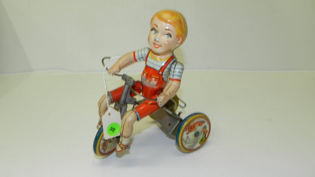 Vintage, tin litho wind up toy, boy on trike, "Kiddy: Vintage, tin litho wind up toy, boy on trike, "Kiddy Cyclist" by Unique Art Toy Co., works. 8 x 7